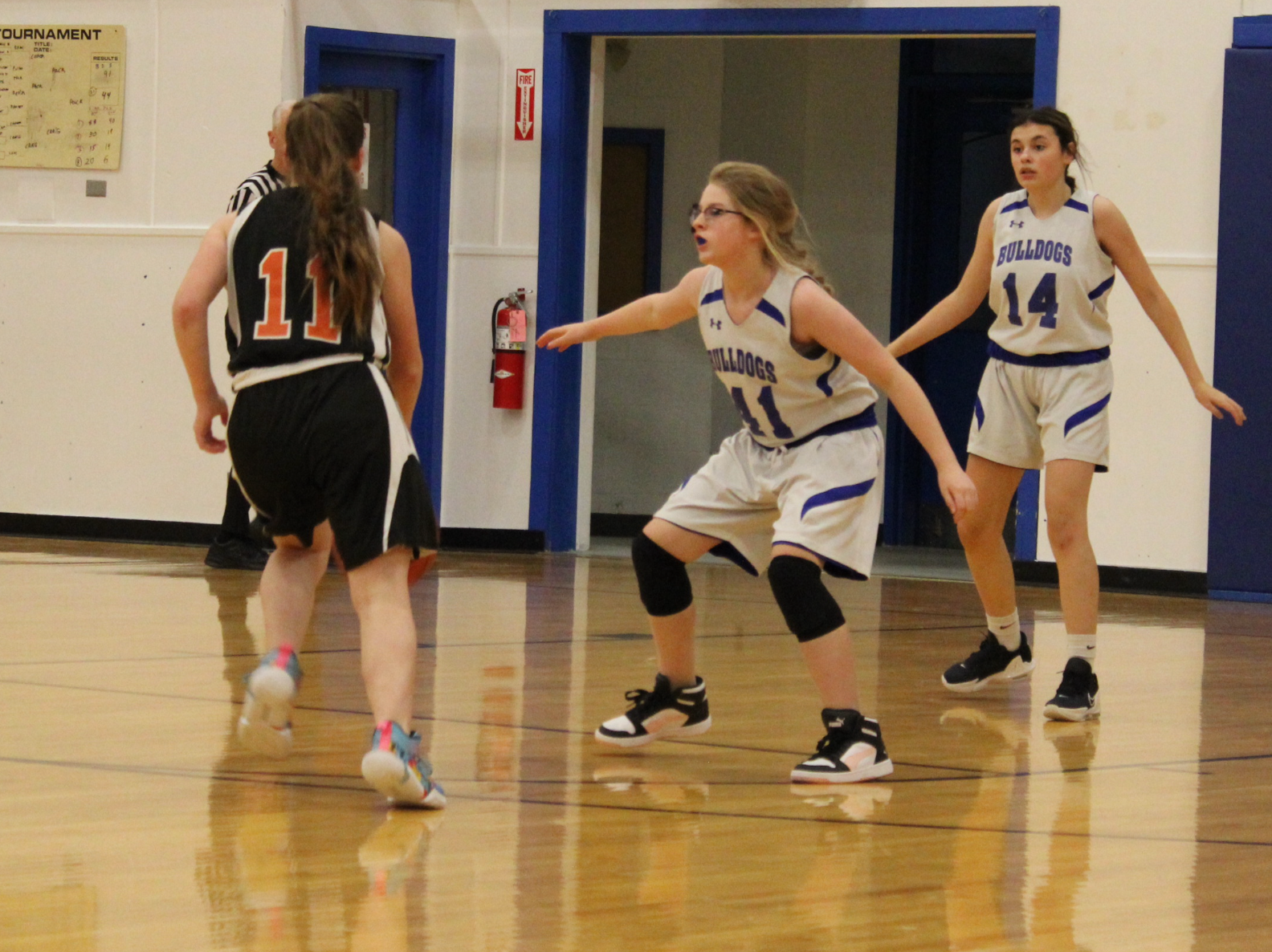 A basketball player with the number 11 on her jersey