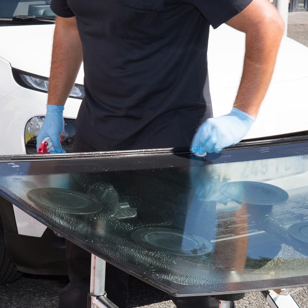 technician replacing a windshield