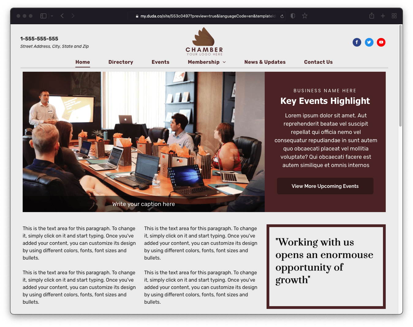 A group of people are sitting around a table with laptops.