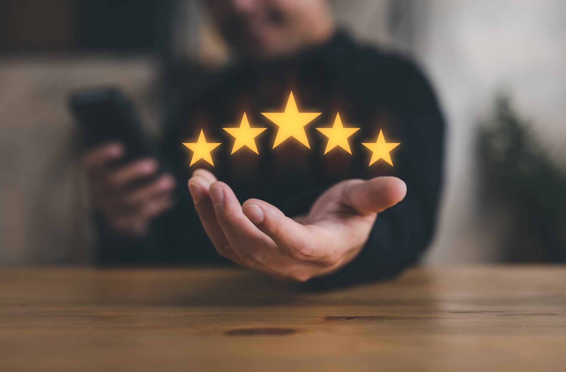 A person is holding five stars in their hand.