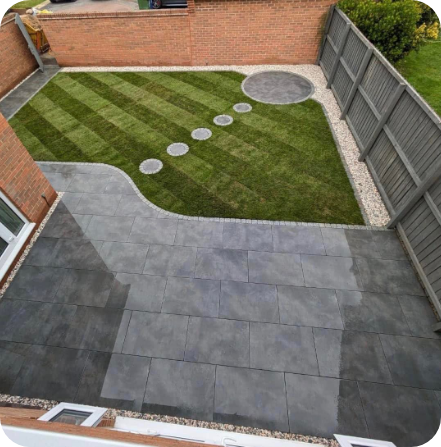 Backyard with gray patio, green lawn with striped mowing, stepping stones, and gravel borders.