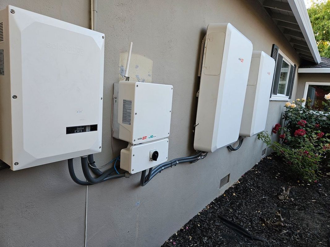 A row of white solar panels on the side of a house