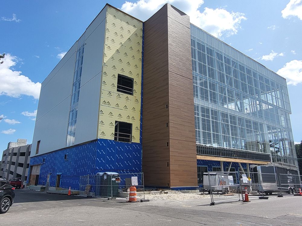 A large building is being built on a sunny day.