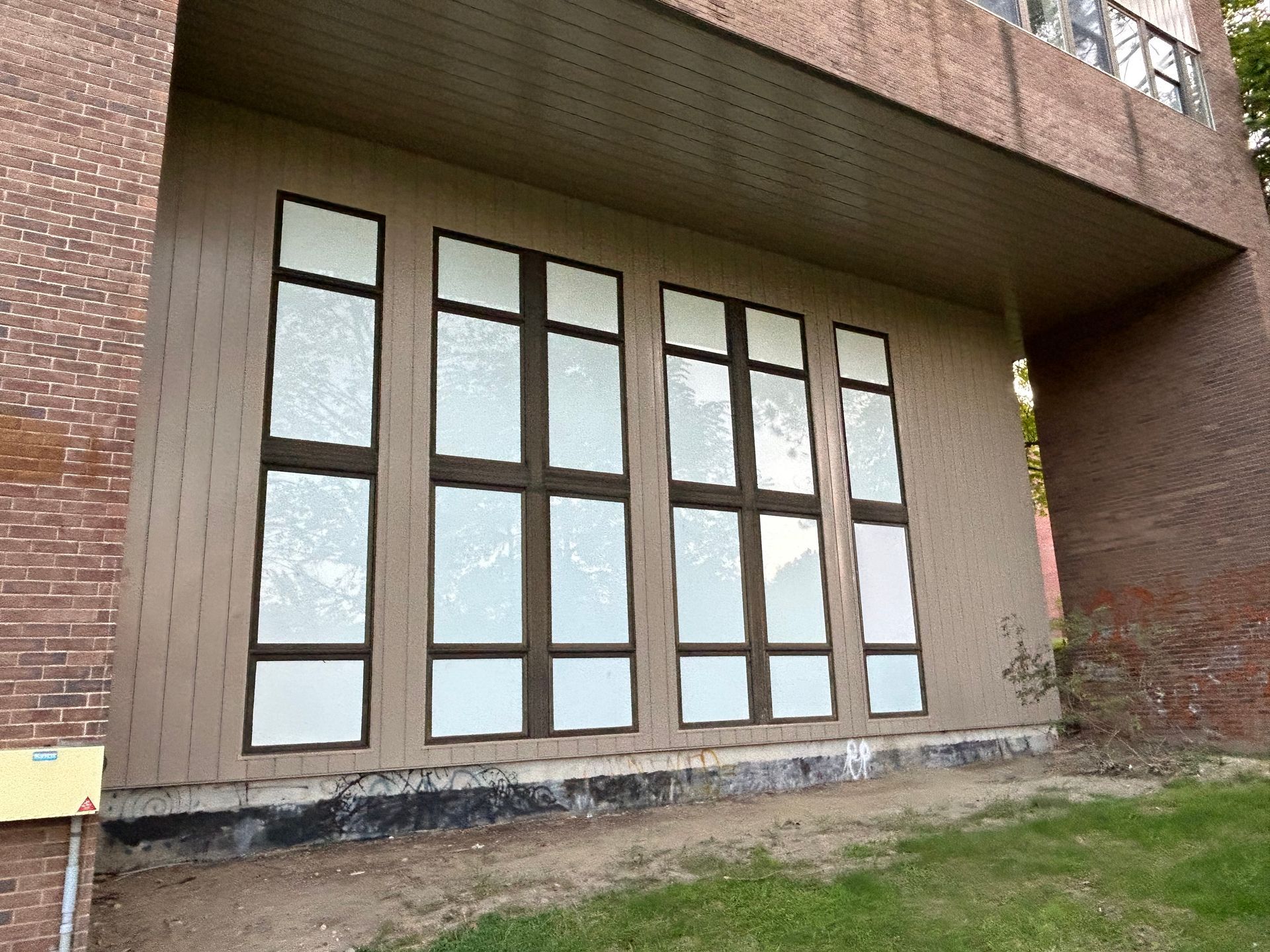 A brick building with a lot of windows on it