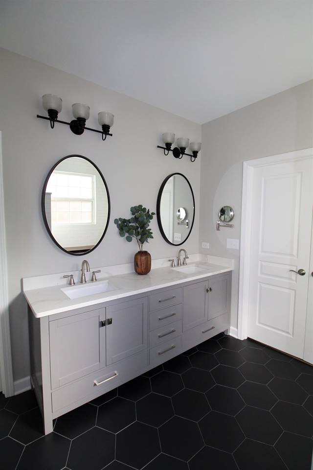 A bathroom with two sinks and two mirrors.