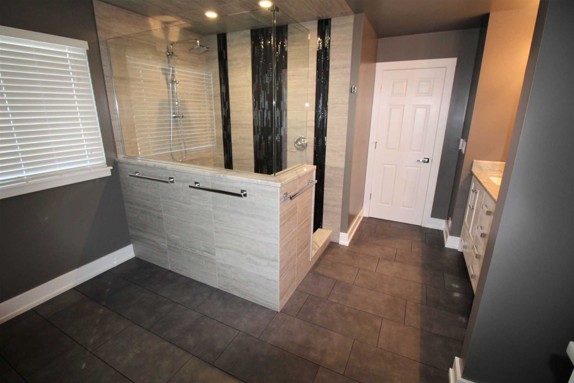 A bathroom with a walk in shower and a bathtub