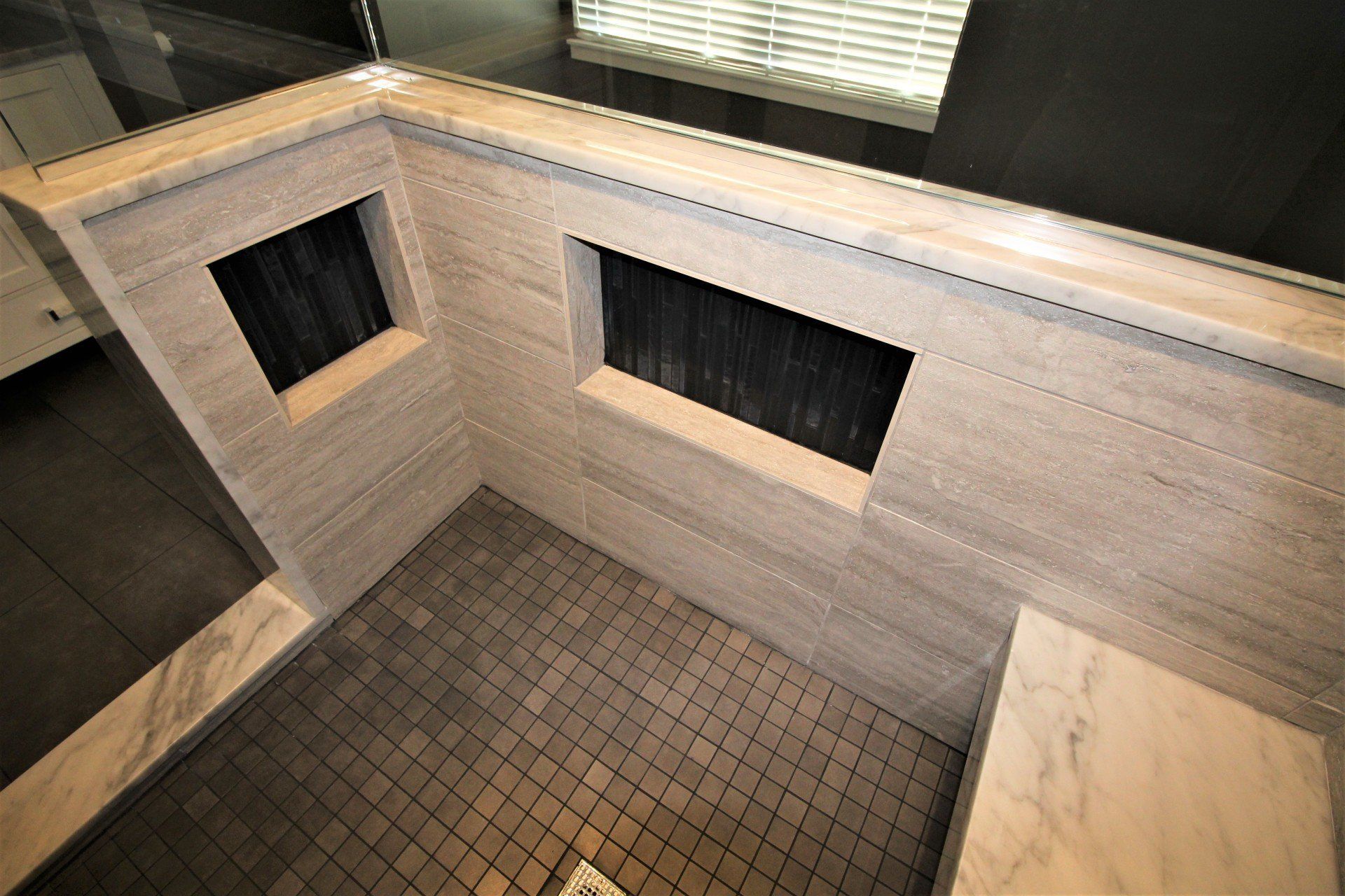 A bathroom with a tiled floor and a mirror