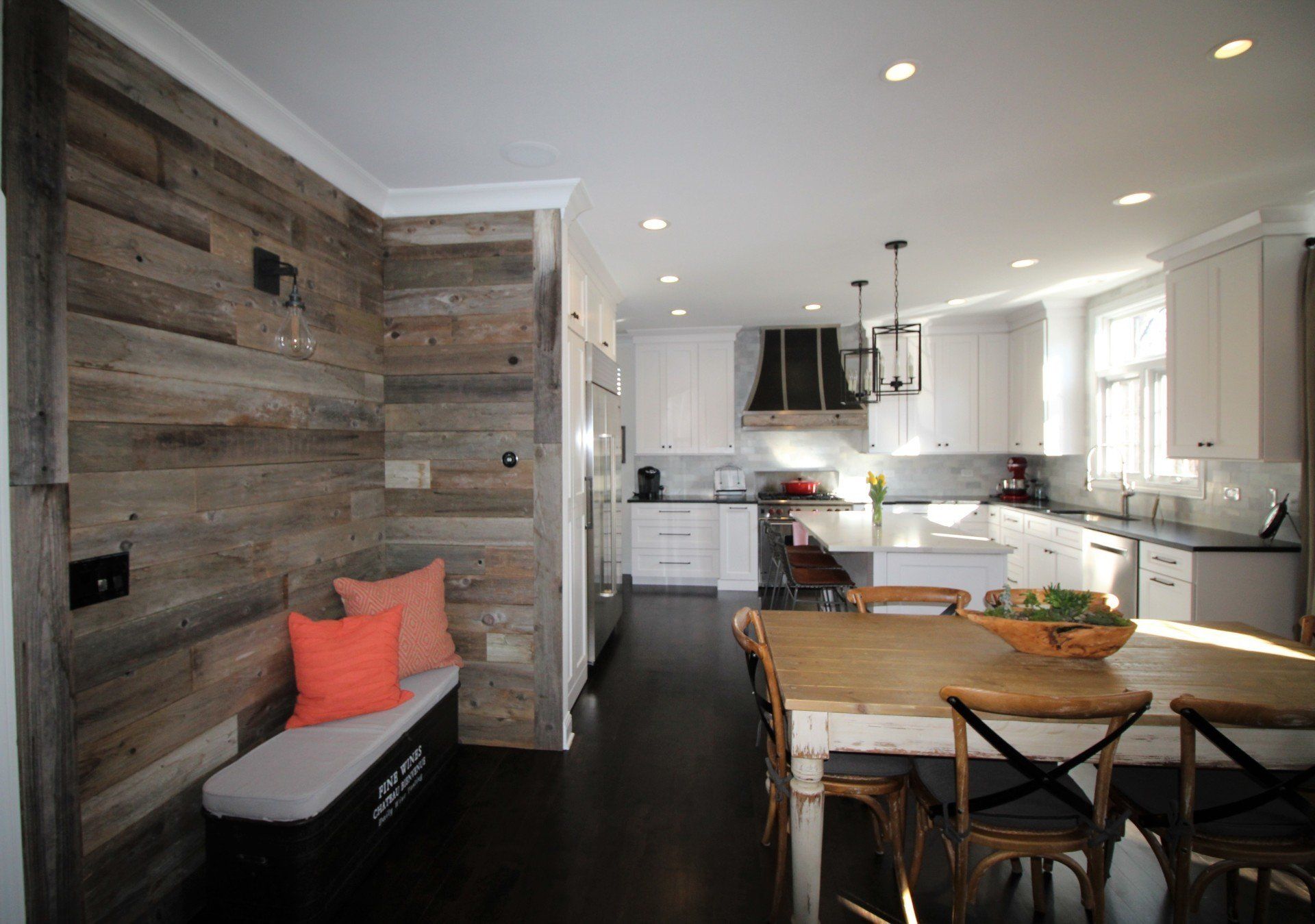 A kitchen with a table and chairs and a wooden wall