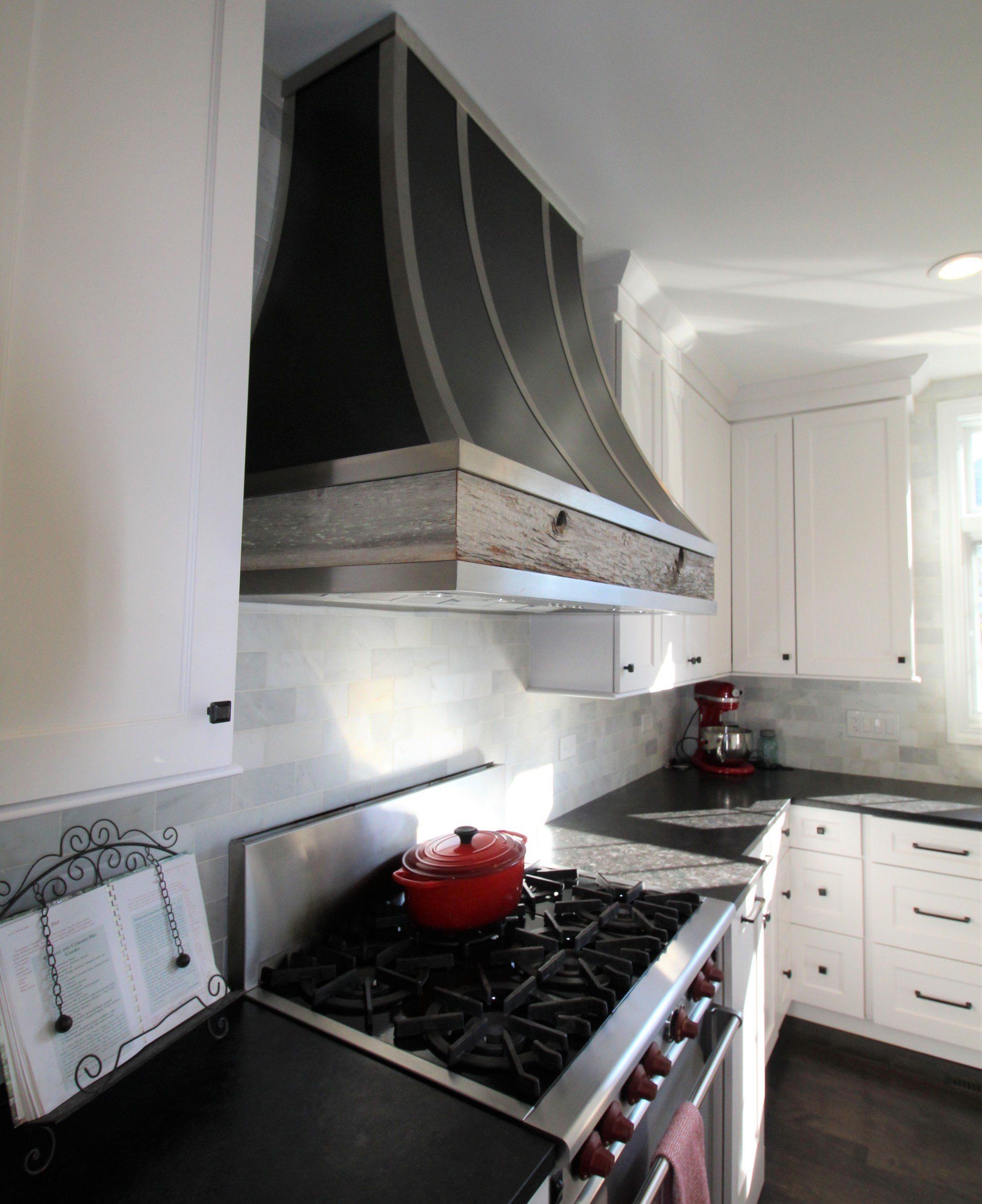 A kitchen with stainless steel appliances and white cabinets