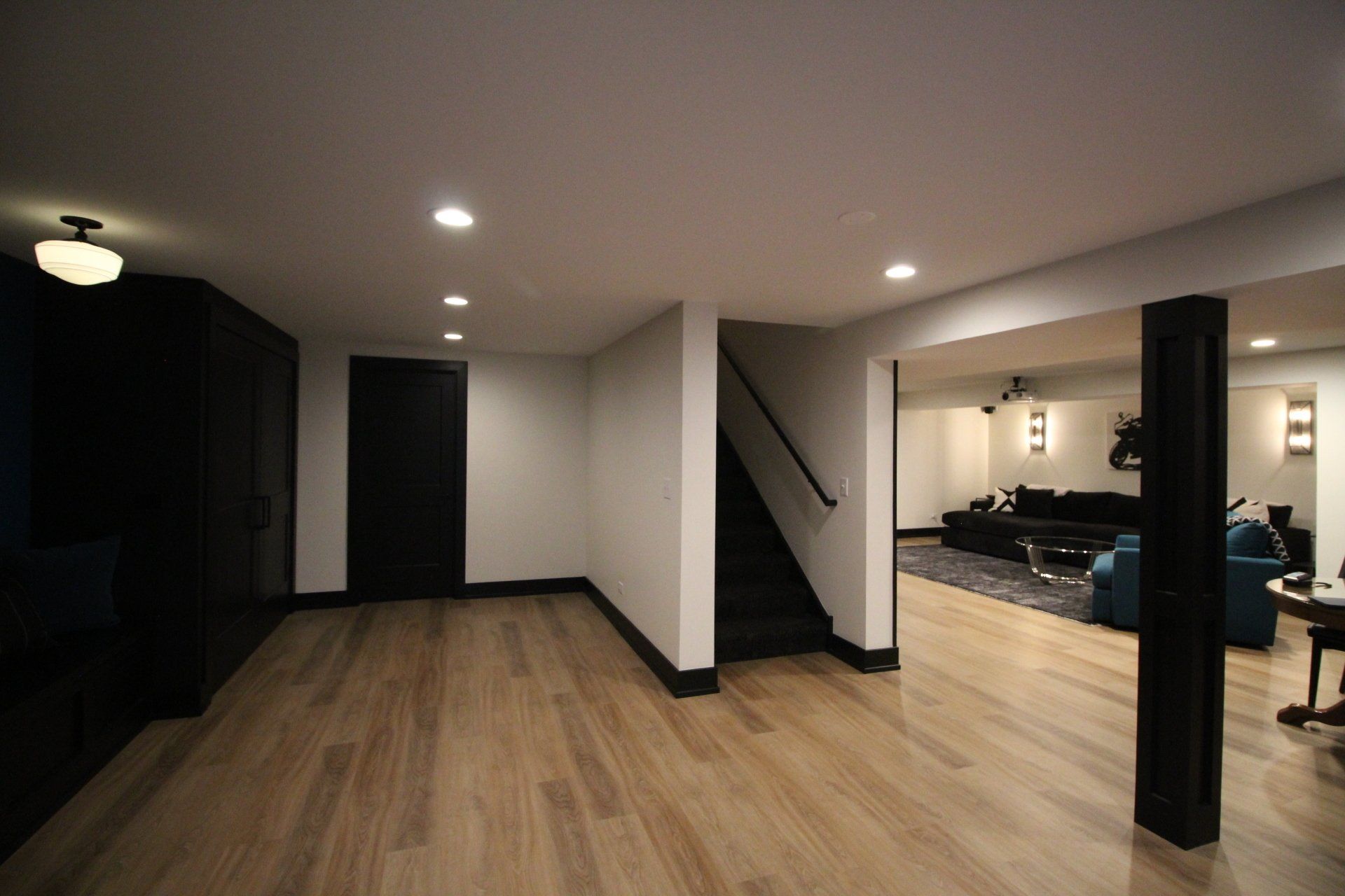 A basement with hardwood floors and a staircase