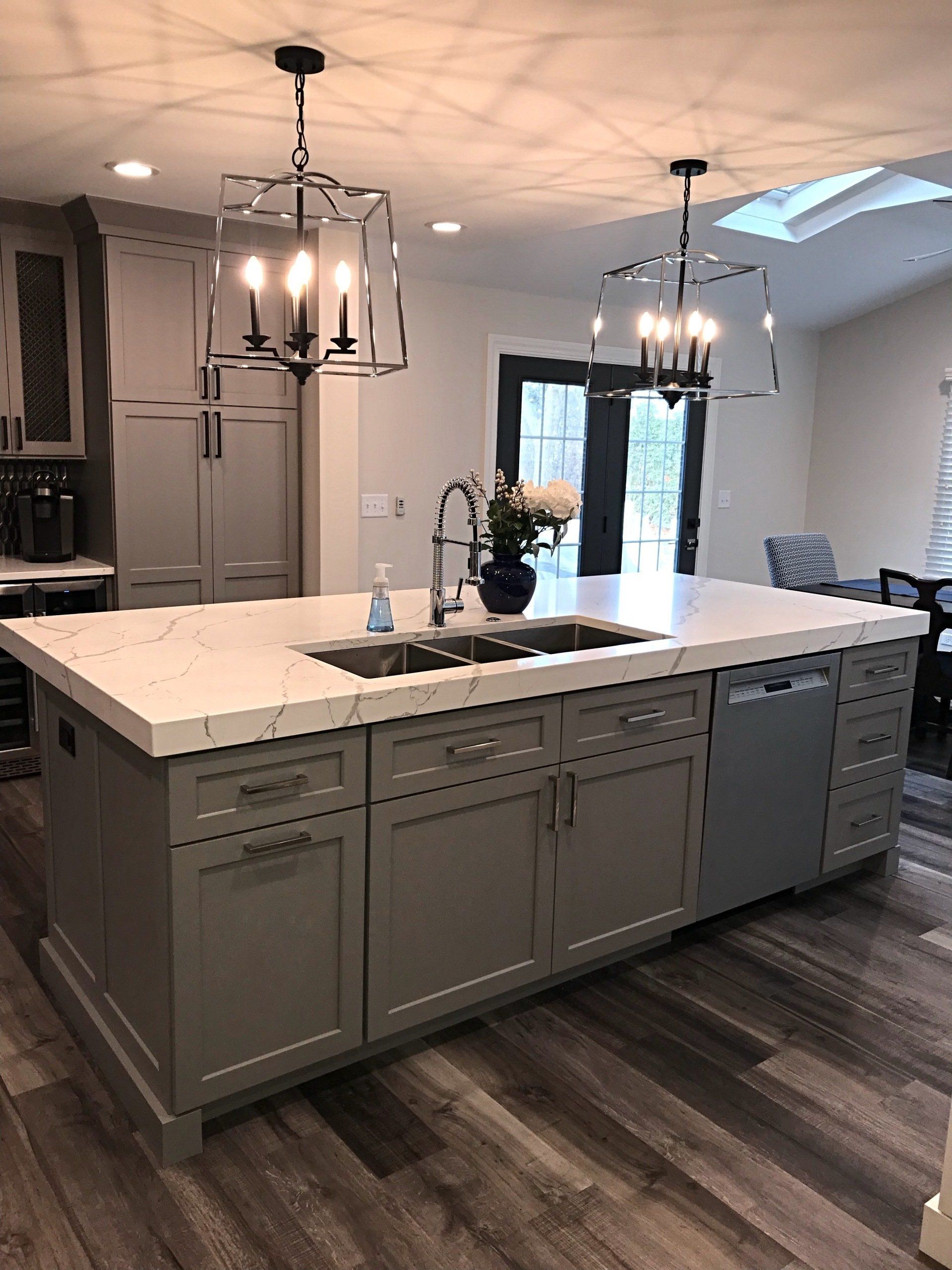 A kitchen with a large island and a sink.