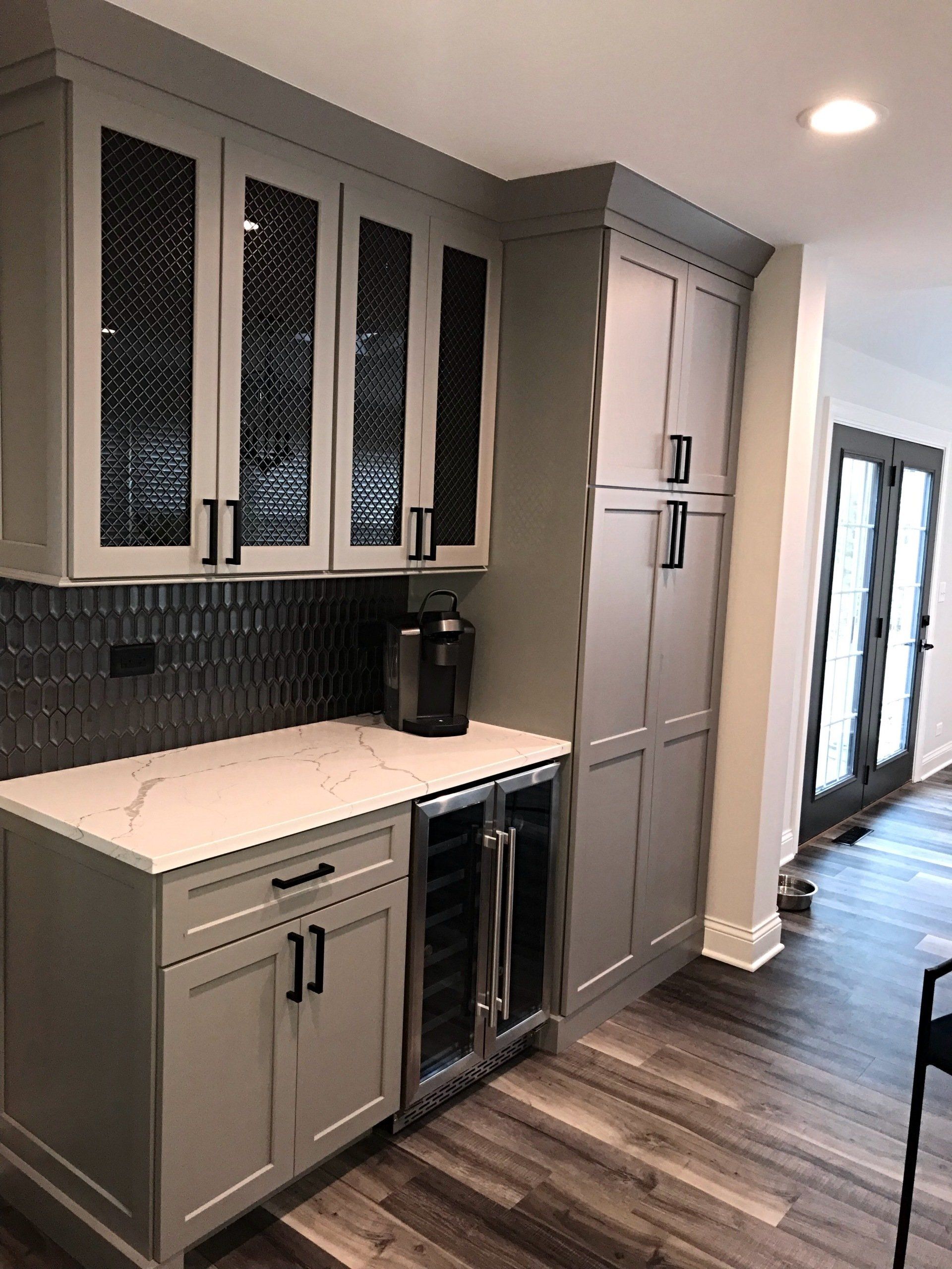 A kitchen with white cabinets and stainless steel appliances.
