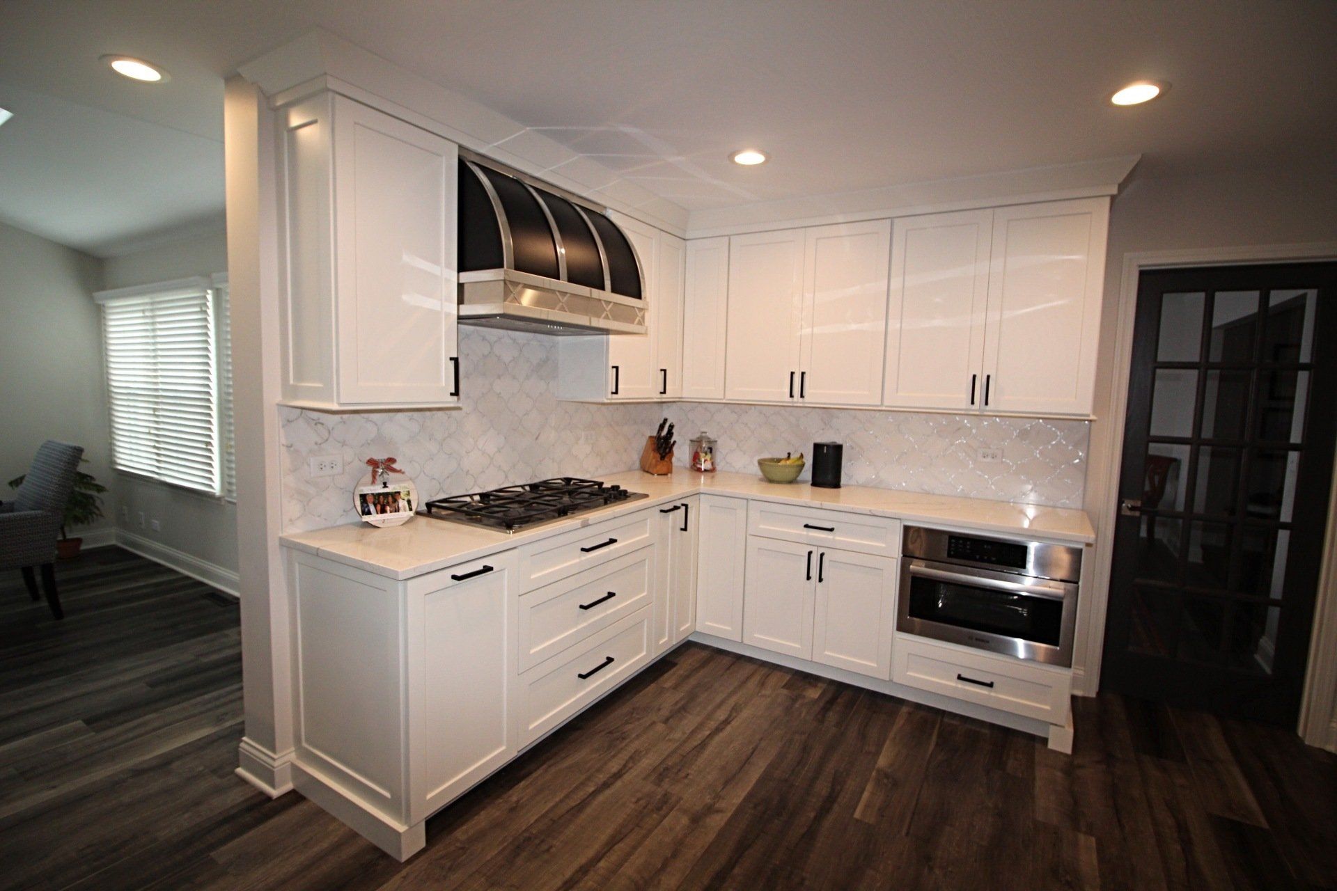 A kitchen with white cabinets and stainless steel appliances.
