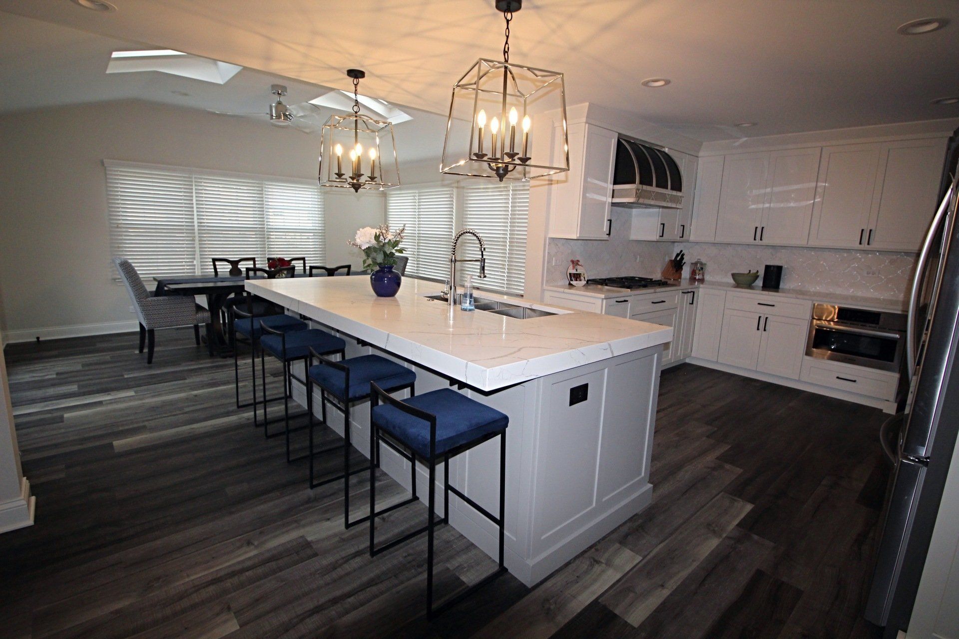 A kitchen with a large island and stools