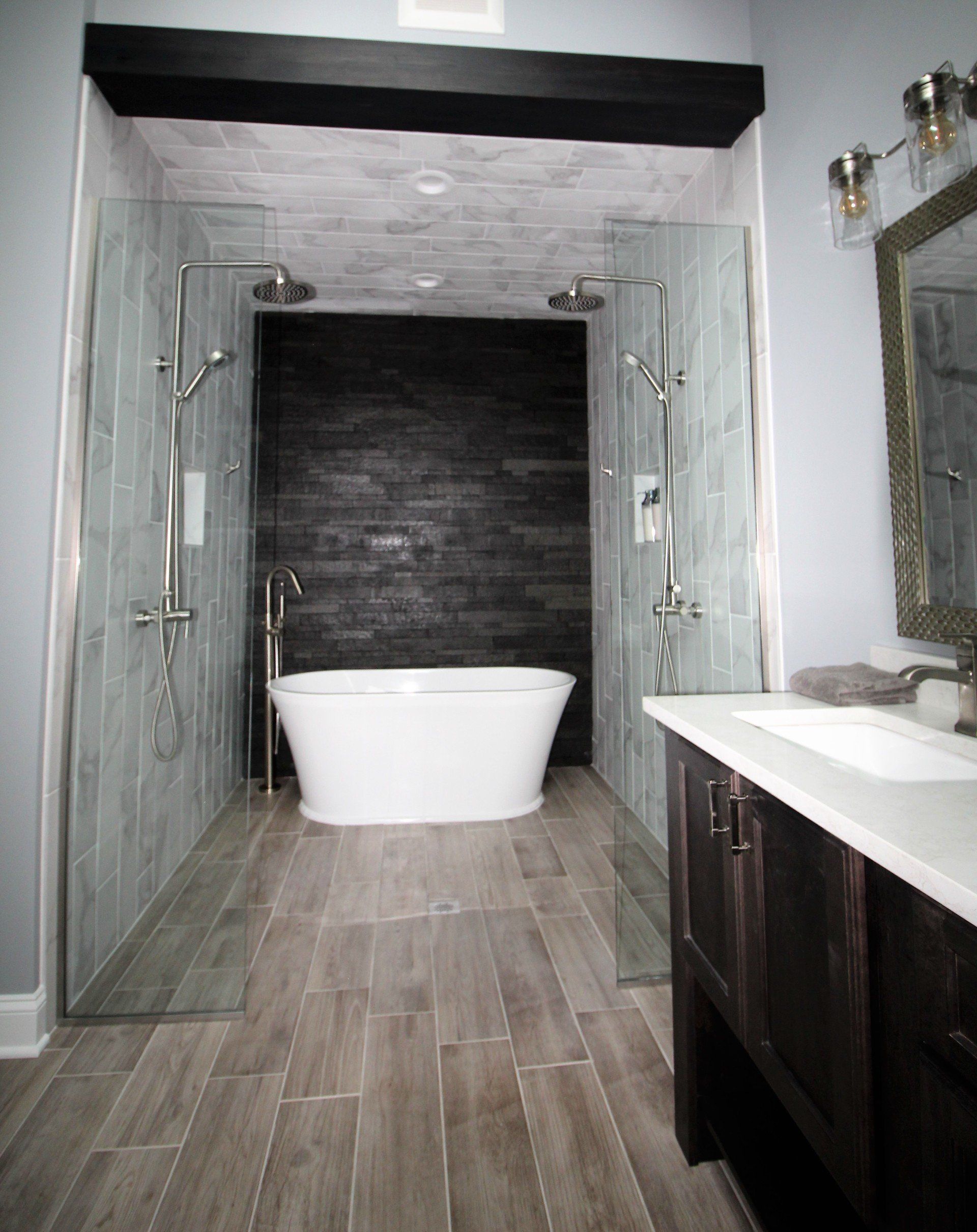 A bathroom with a bathtub , sink , and shower.