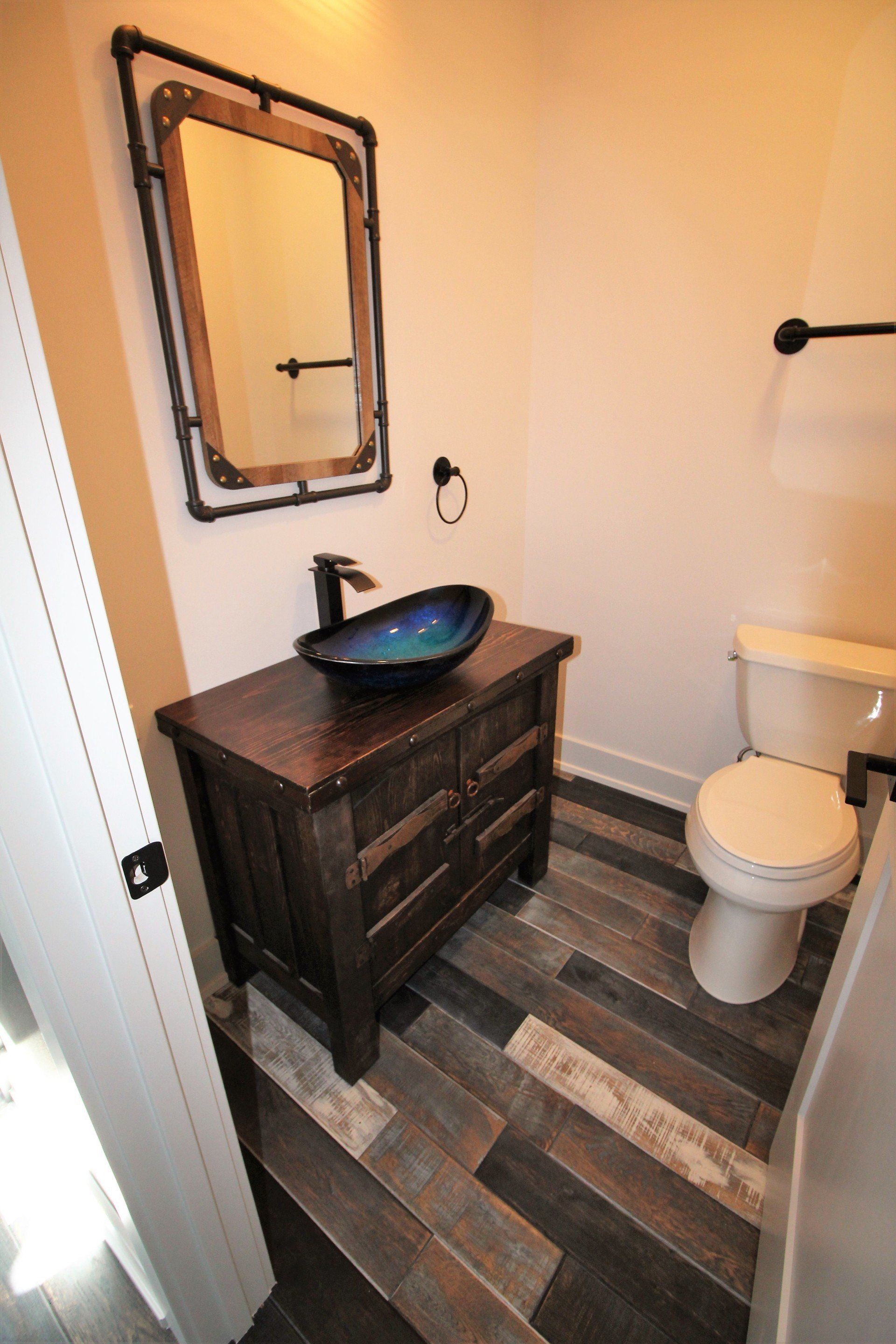 A bathroom with a sink , toilet and mirror.
