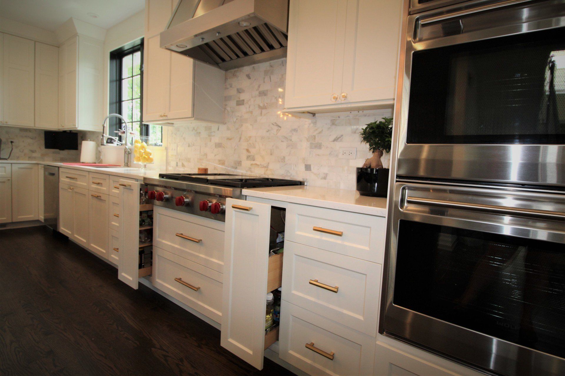A kitchen with white cabinets and stainless steel appliances