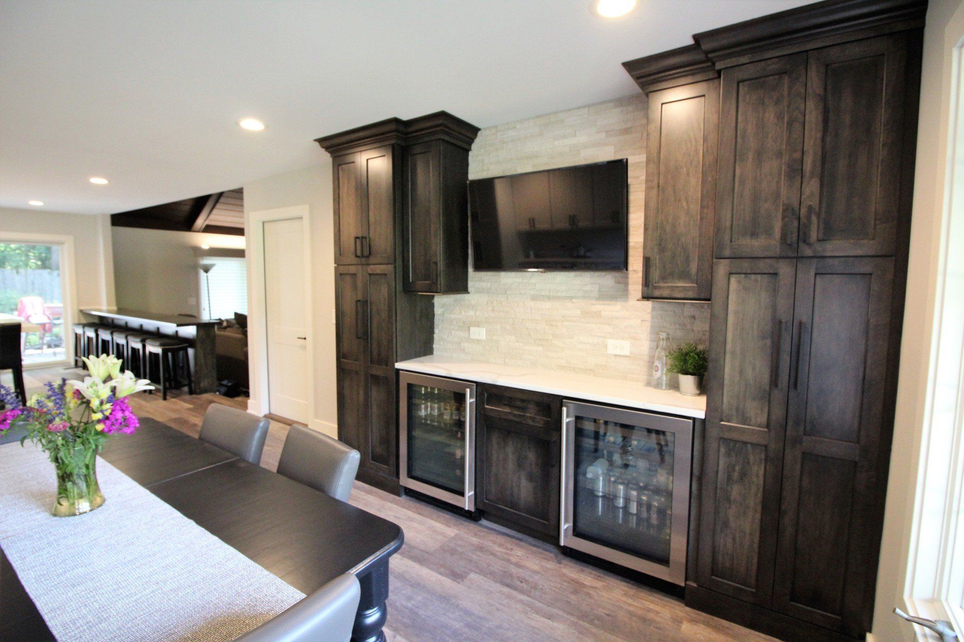 A kitchen with a table and chairs and a refrigerator.