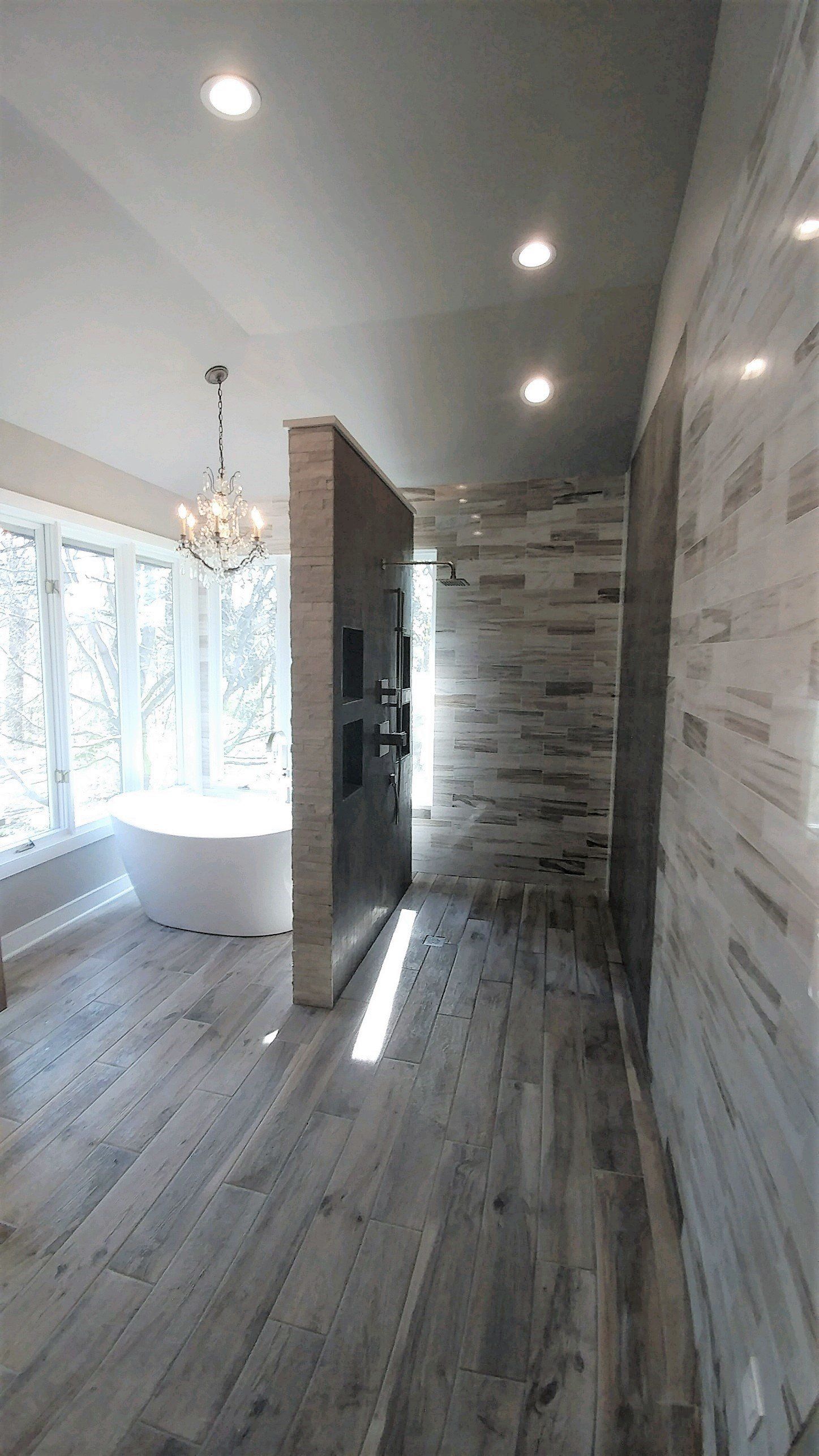A bathroom with a bathtub and a walk in shower.