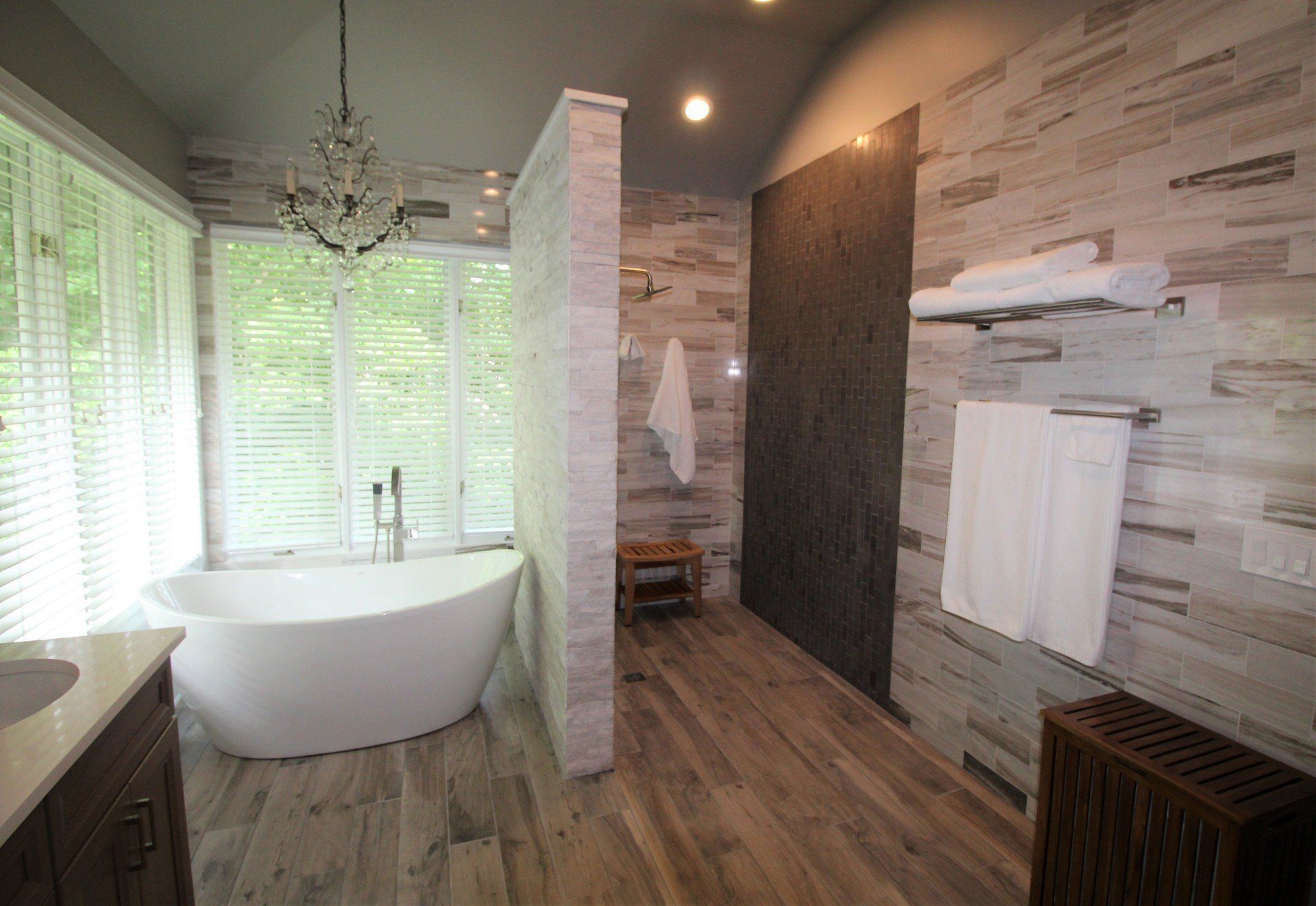 A bathroom with a bathtub and a walk in shower.