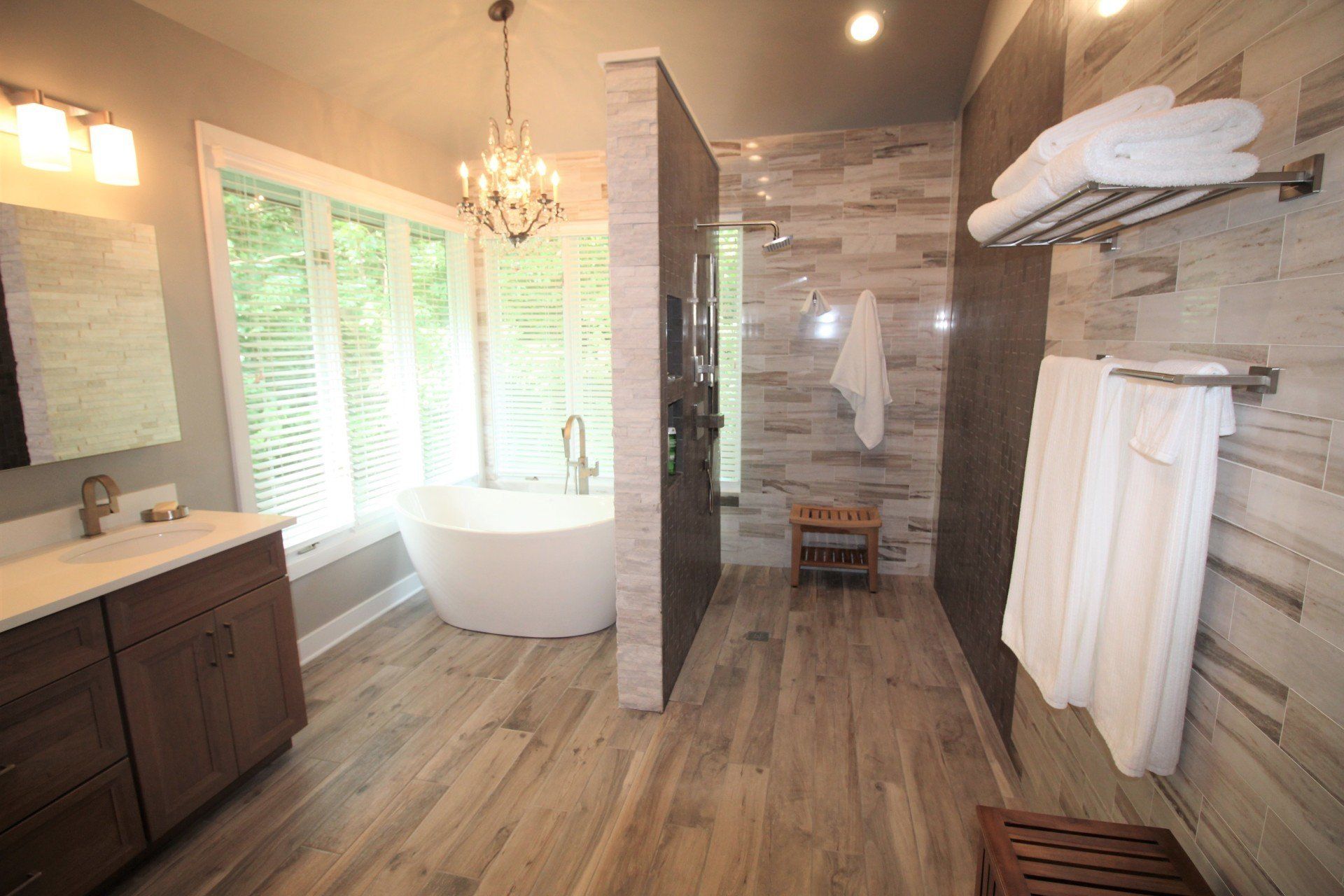 A bathroom with a tub , sink , and shower.