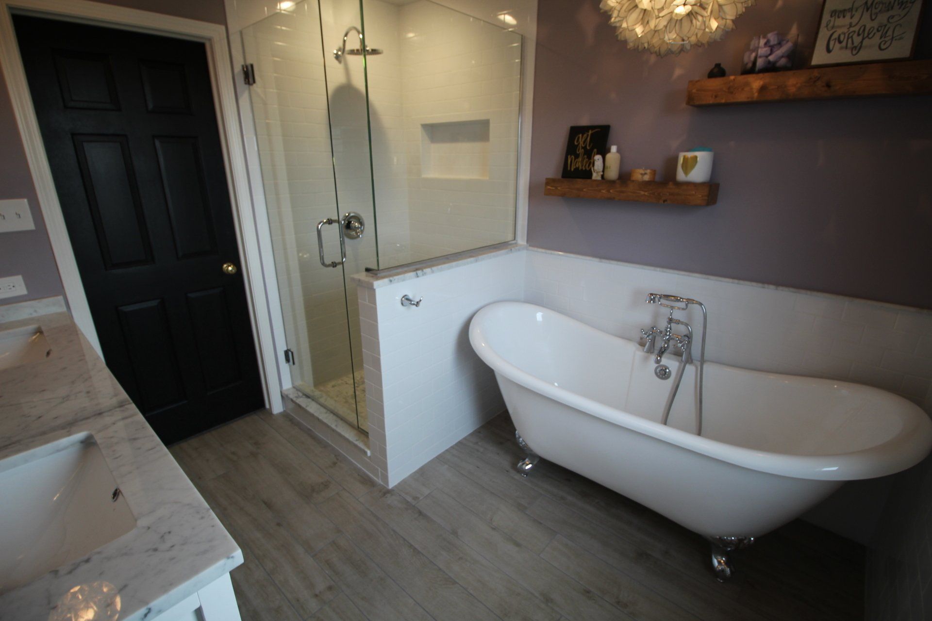 A bathroom with a claw foot tub and a walk in shower