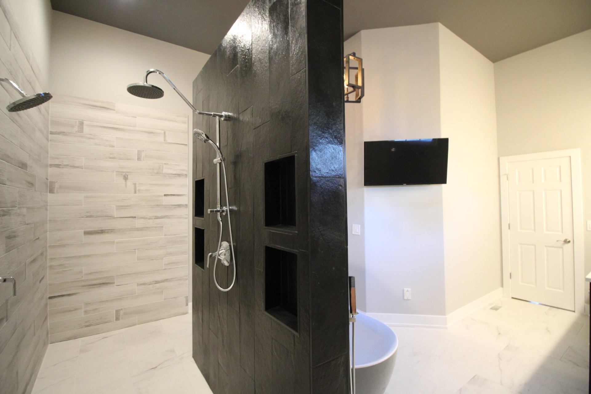 A bathroom with a walk in shower and a bathtub.