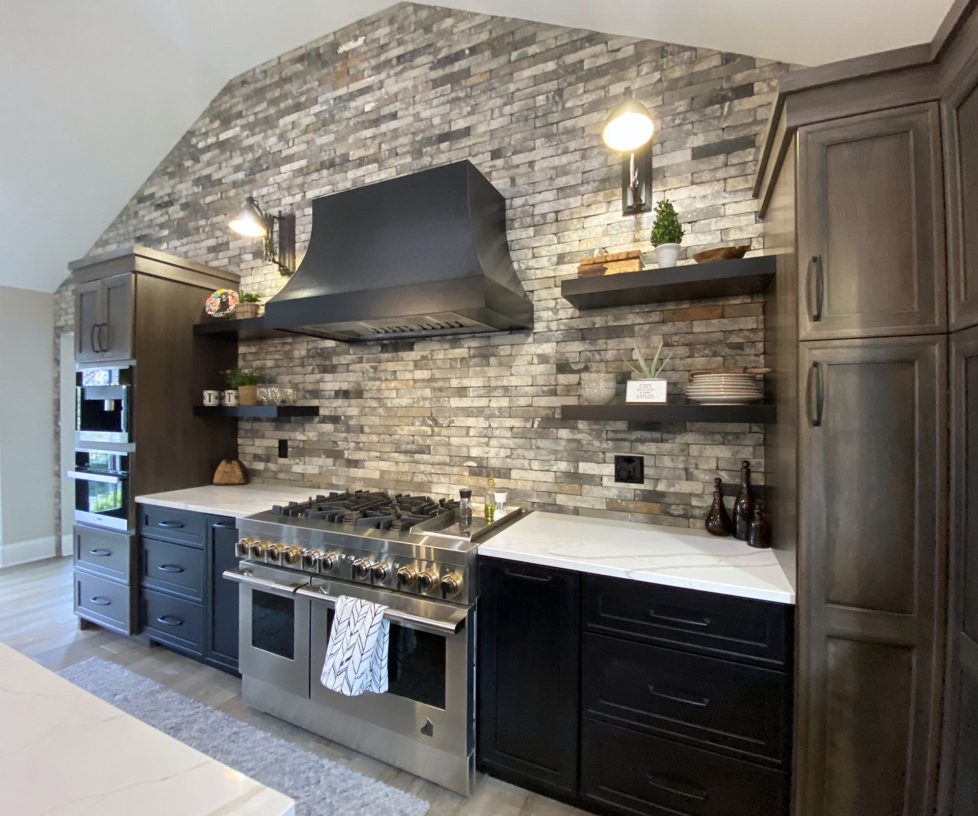 A kitchen with stainless steel appliances and black cabinets