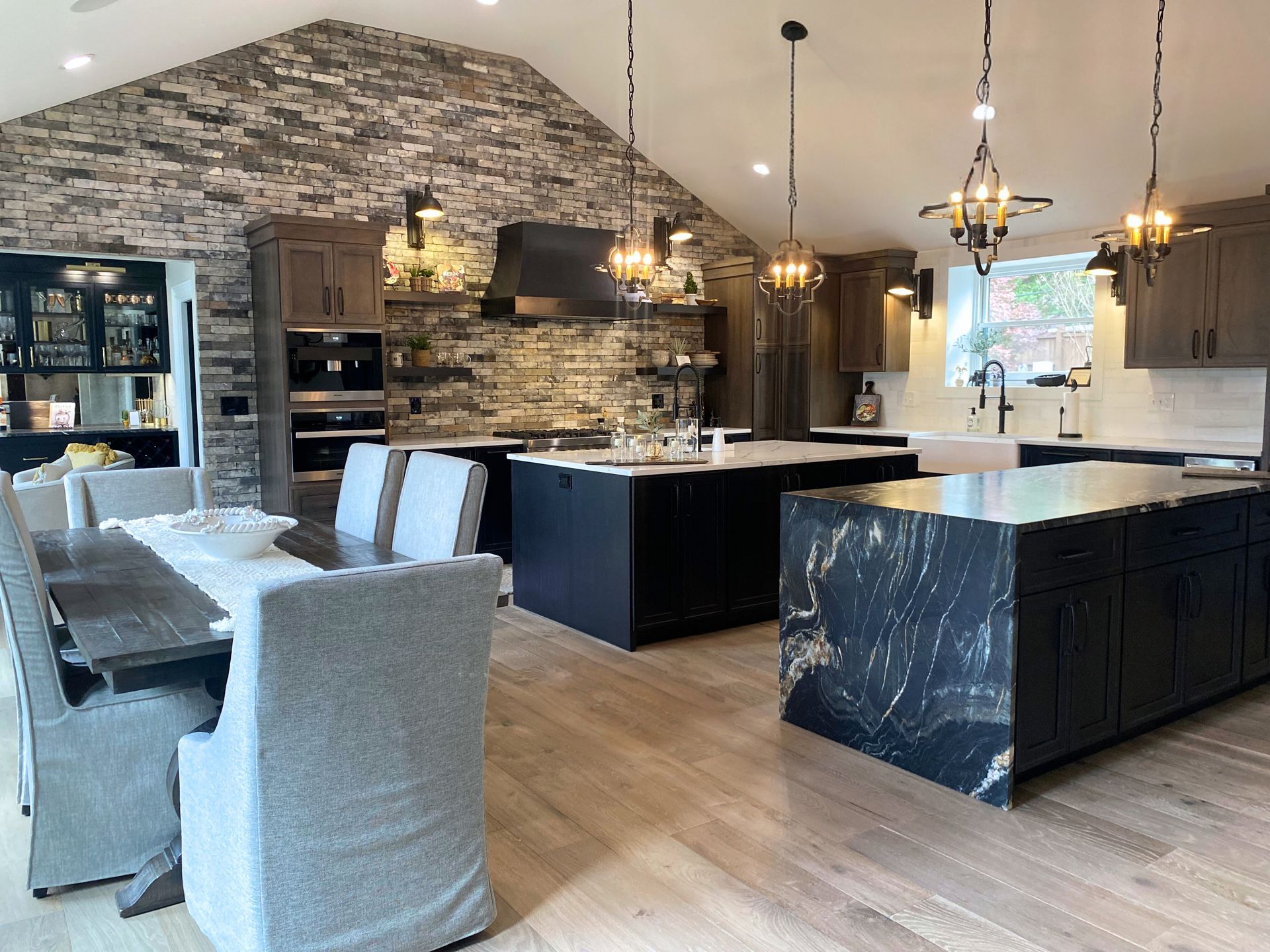 A kitchen and dining room with a large island in the middle