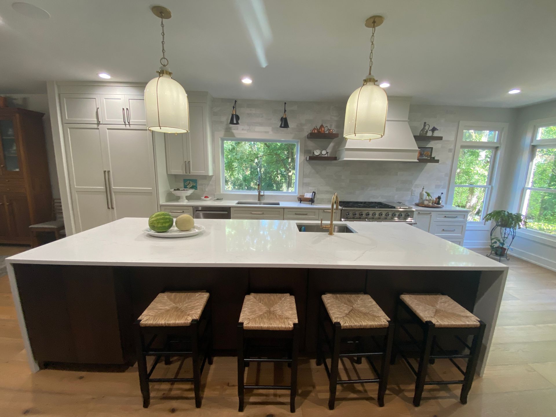 A kitchen with a large island and stools