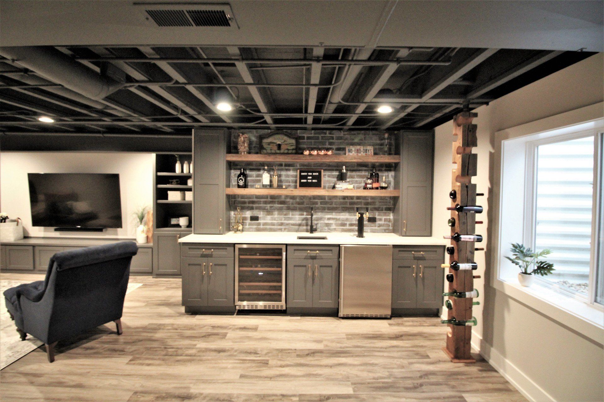 It is a basement with a bar and a couch.