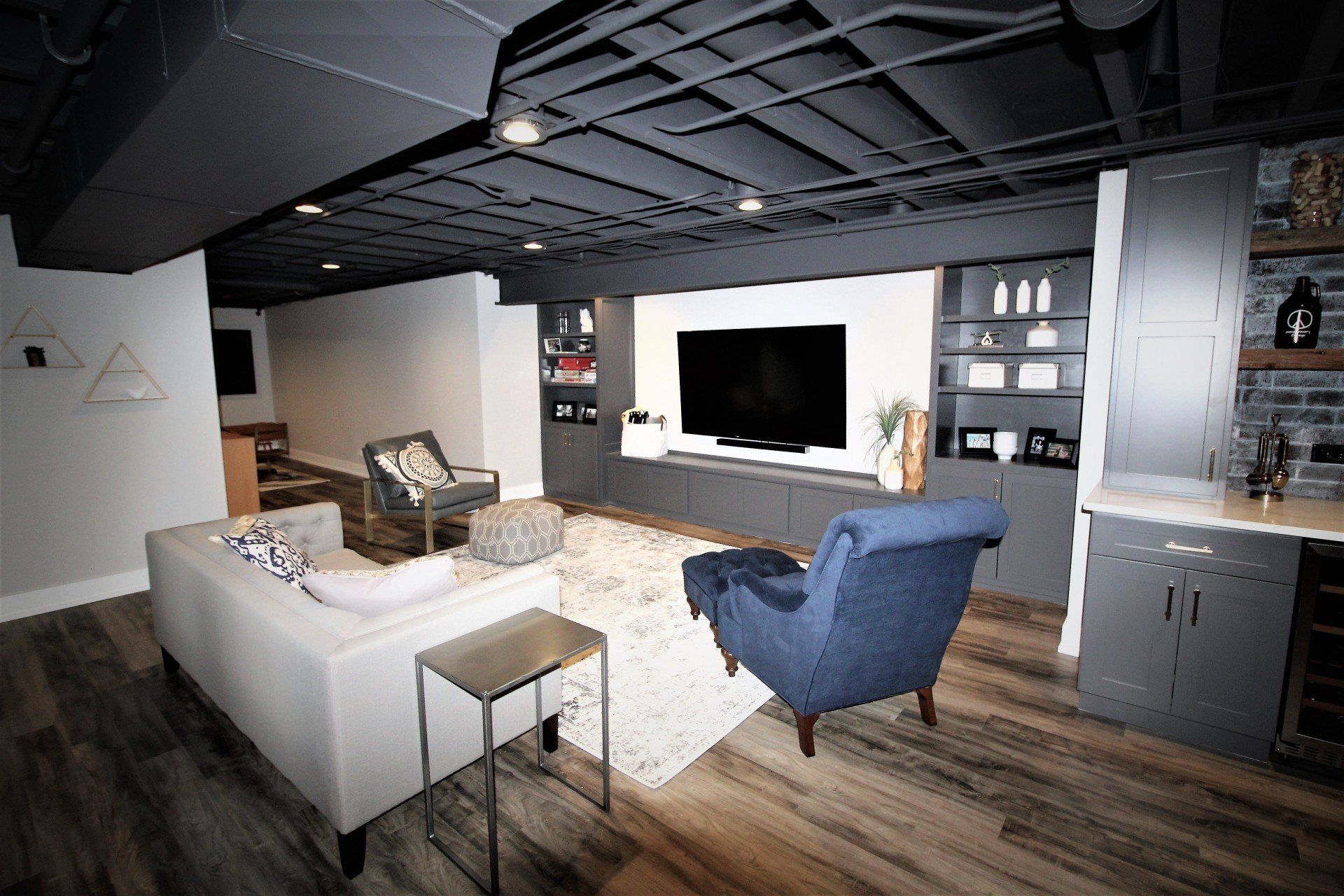 A living room with a couch , chair , and television.