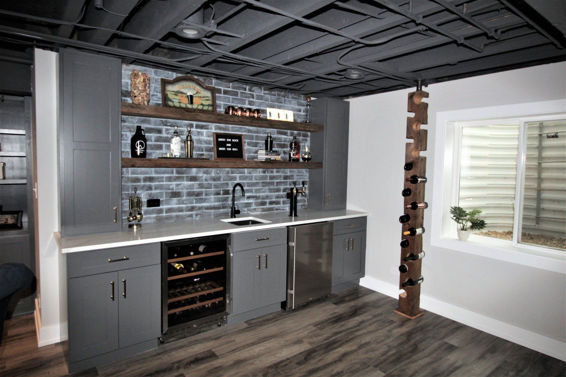 There is a wine rack in the middle of the room.