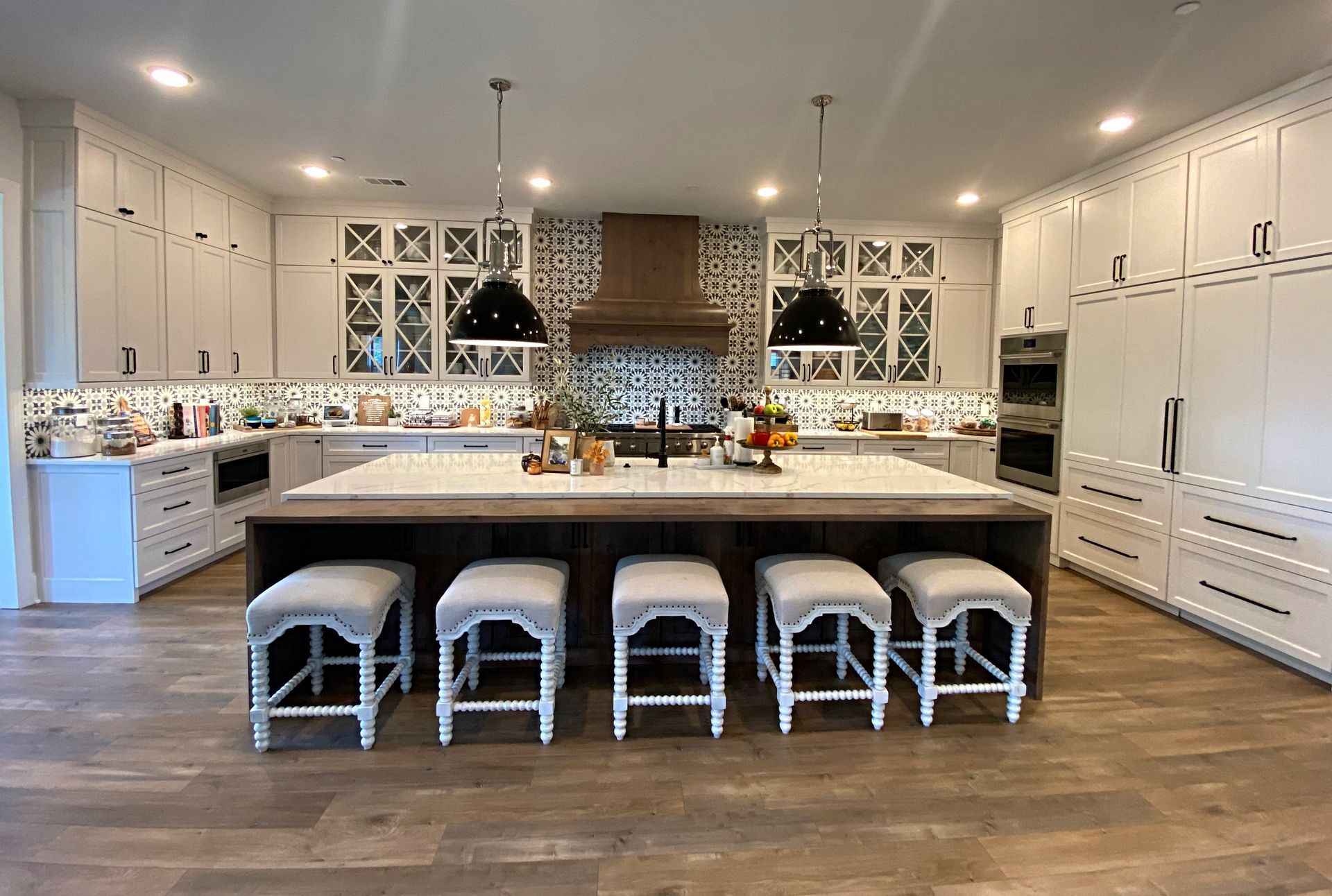A large kitchen with a large island and stools.