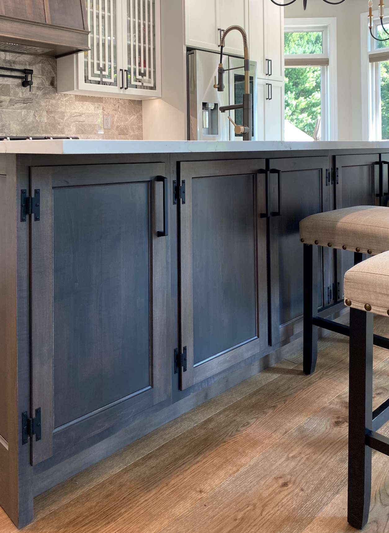 A kitchen with a large island and stools