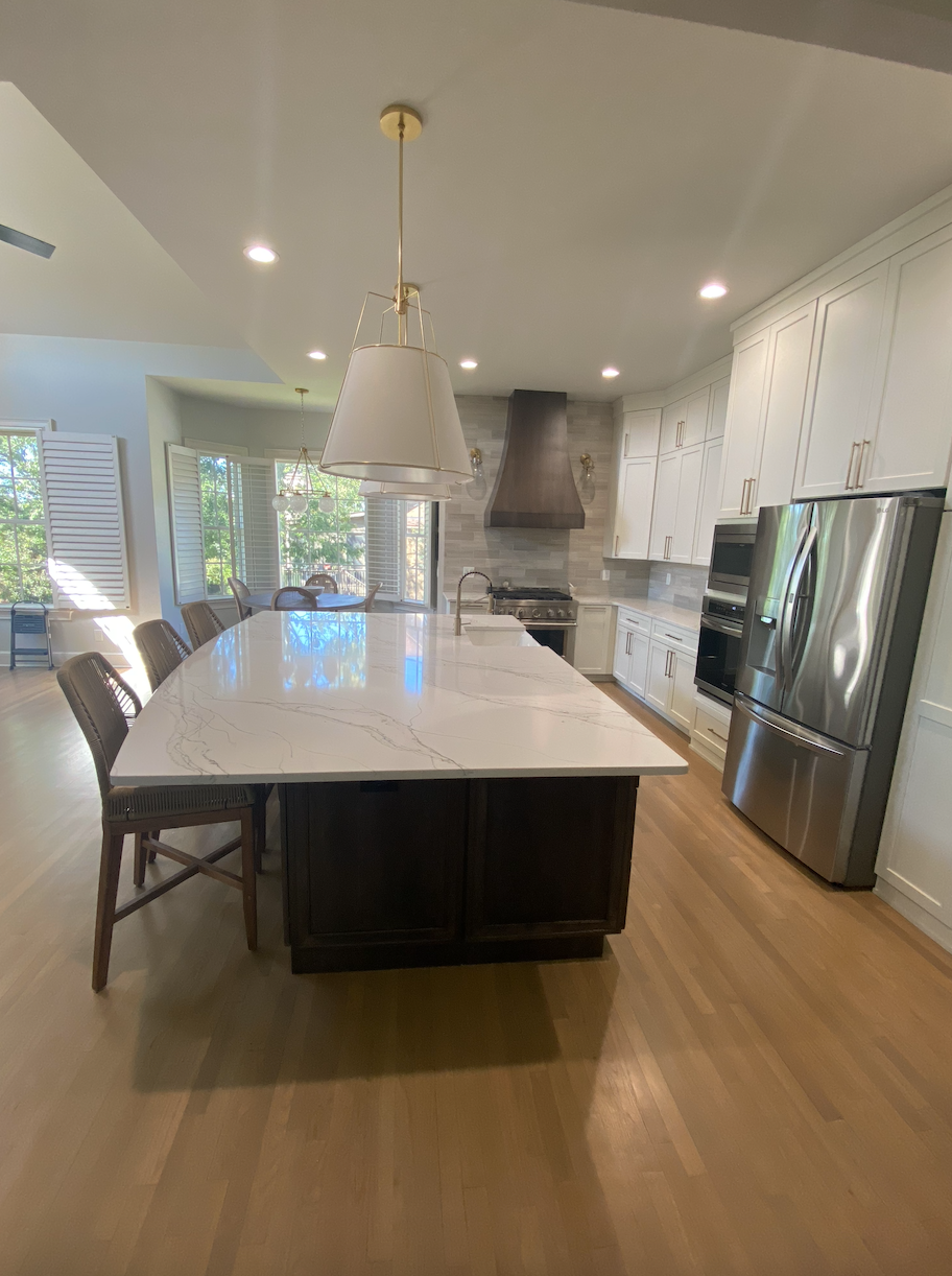 A kitchen with a large island and stainless steel appliances.