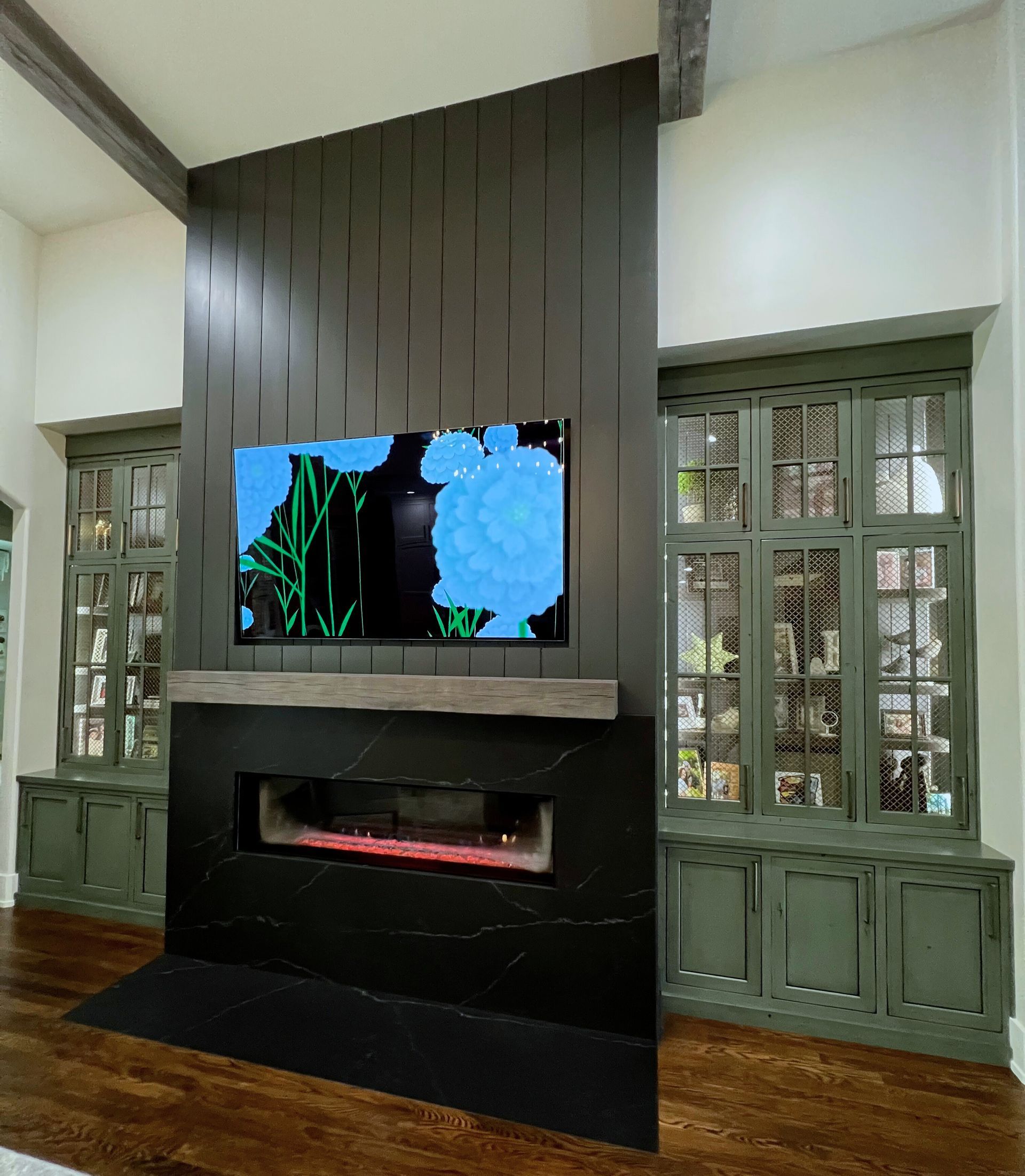 A living room with a fireplace and a flat screen tv