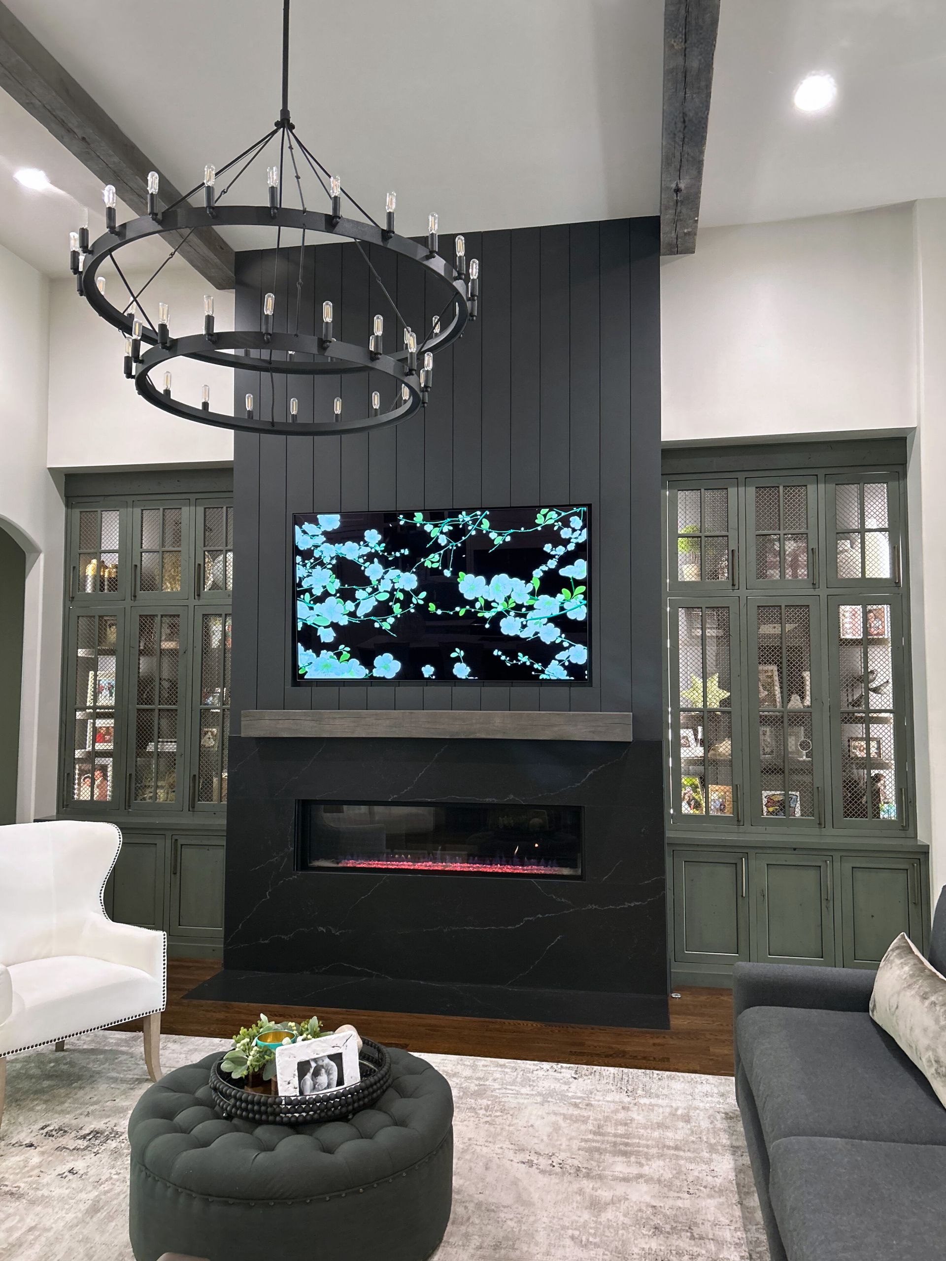 A living room with a fireplace and a flat screen tv