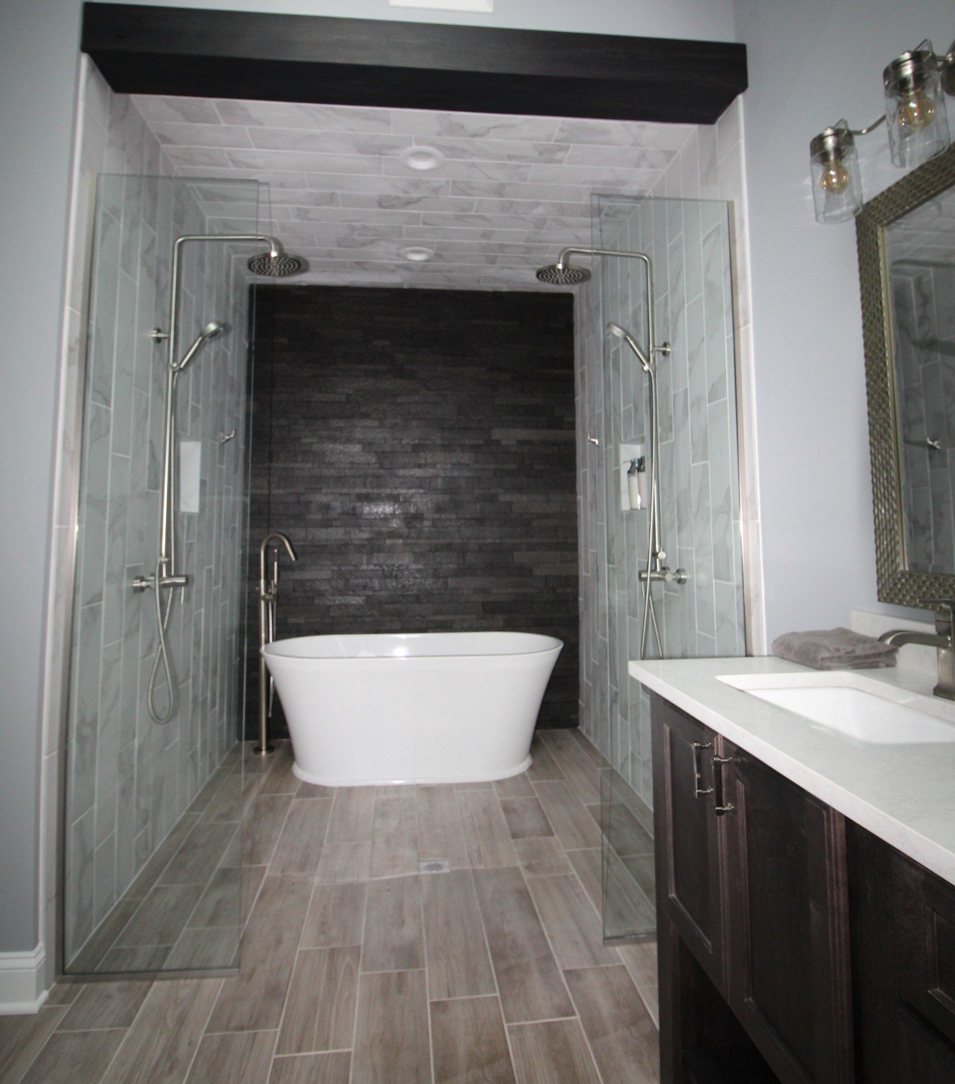 A bathroom with a bathtub , sink , and shower.