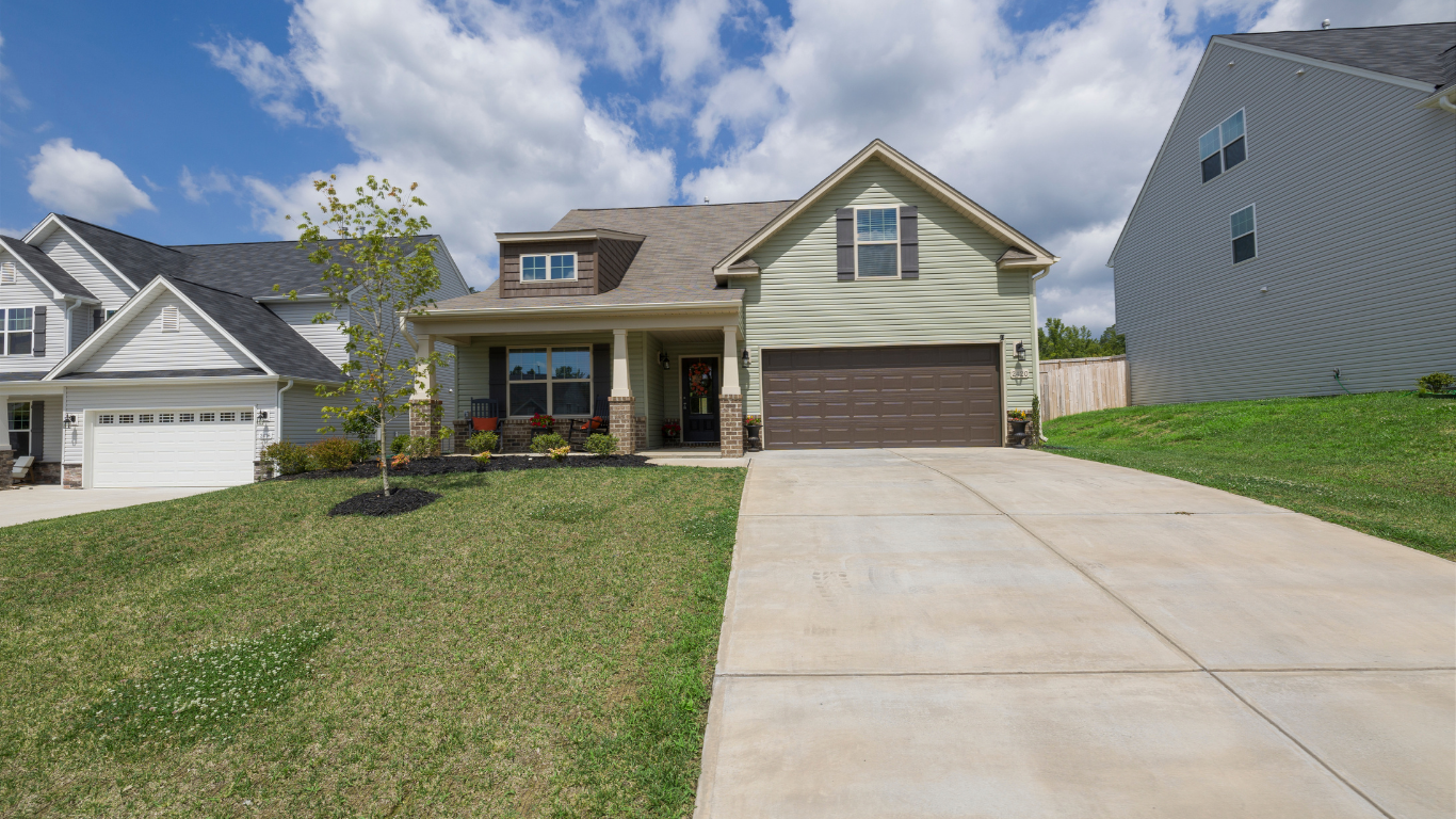 A house with a concrete driveway leading to it