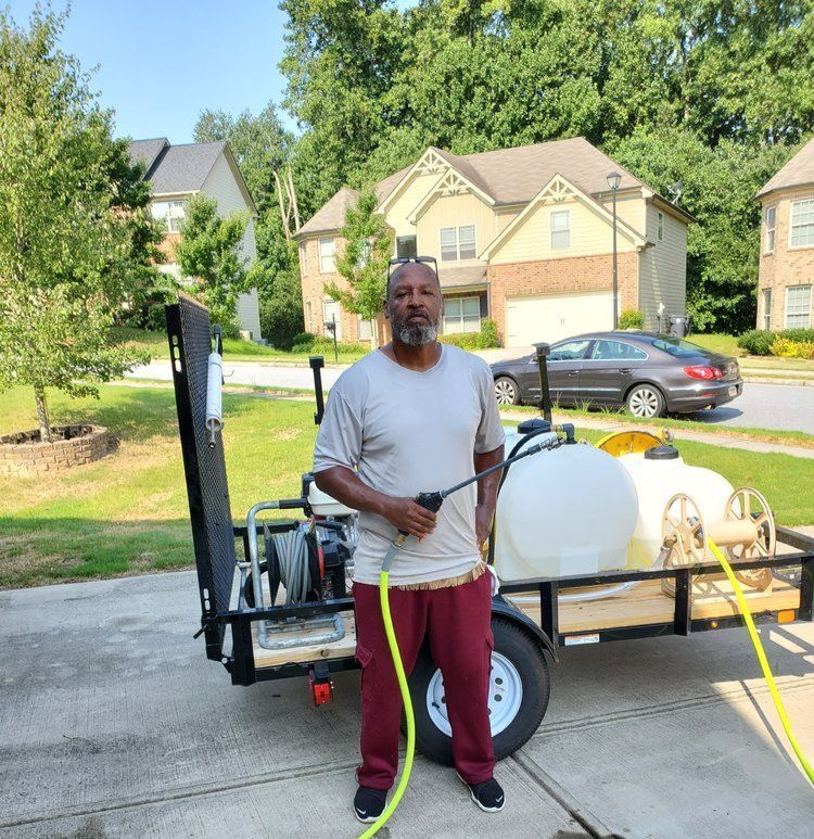 A man is standing next to a trailer with a hose attached to it