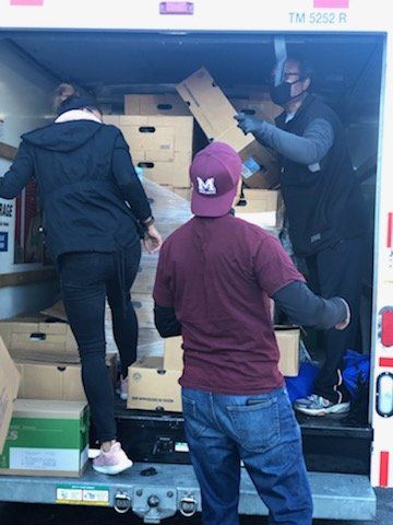 Shirley's Haven Volunteers Unloading Truck For Community