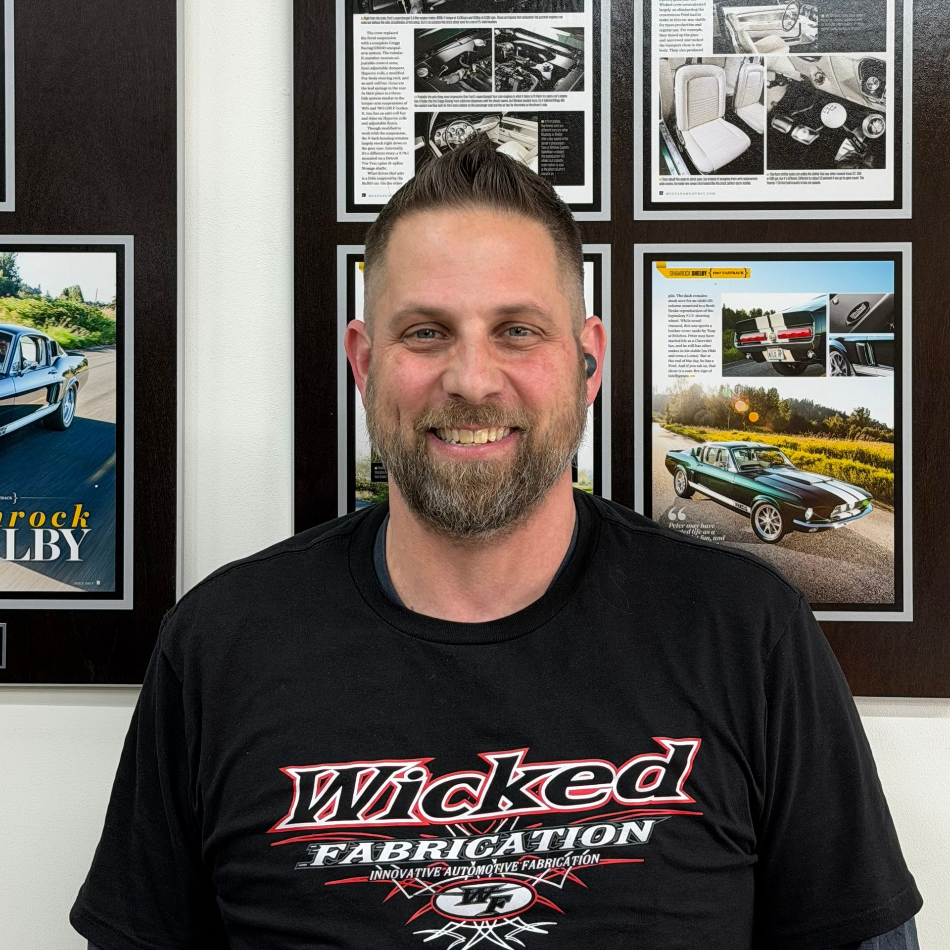 A man wearing a black shirt that says wicked fabrication