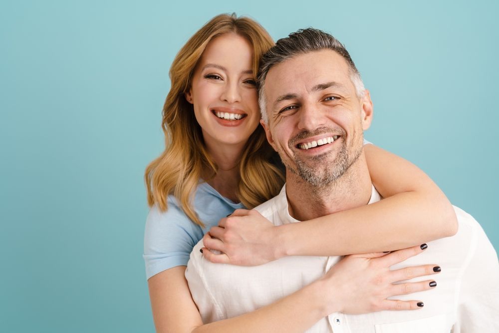 “Smiling couple showing healthy, confident smiles after cosmetic dentistry at Brookside Dental Associates in Redlands, CA.”