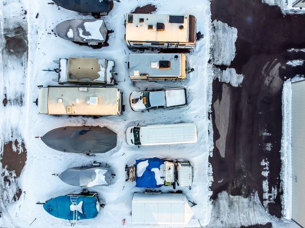 An aerial view of a row of trailers parked in the snow.