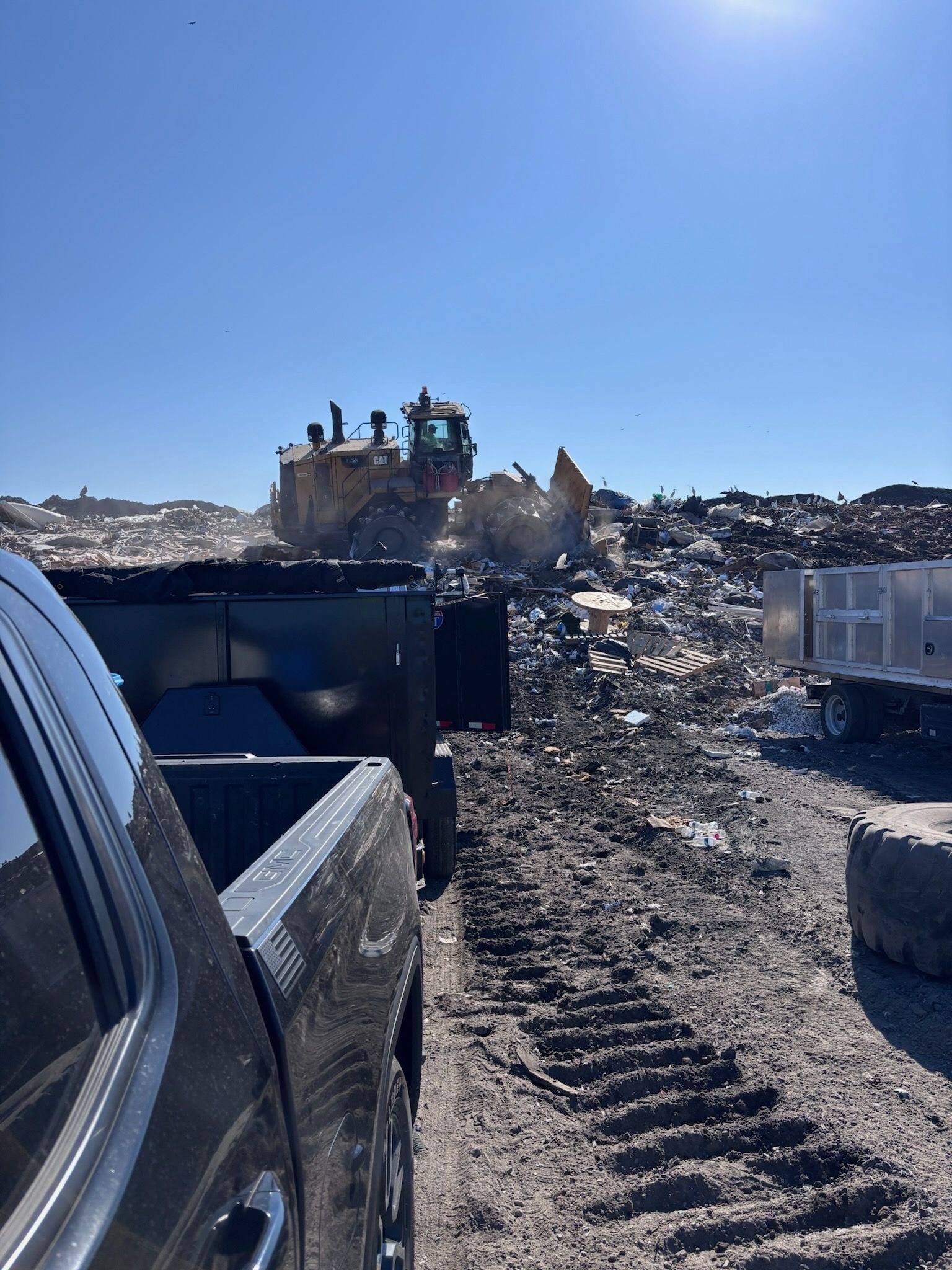 A yellow cat excavator is demolishing a building