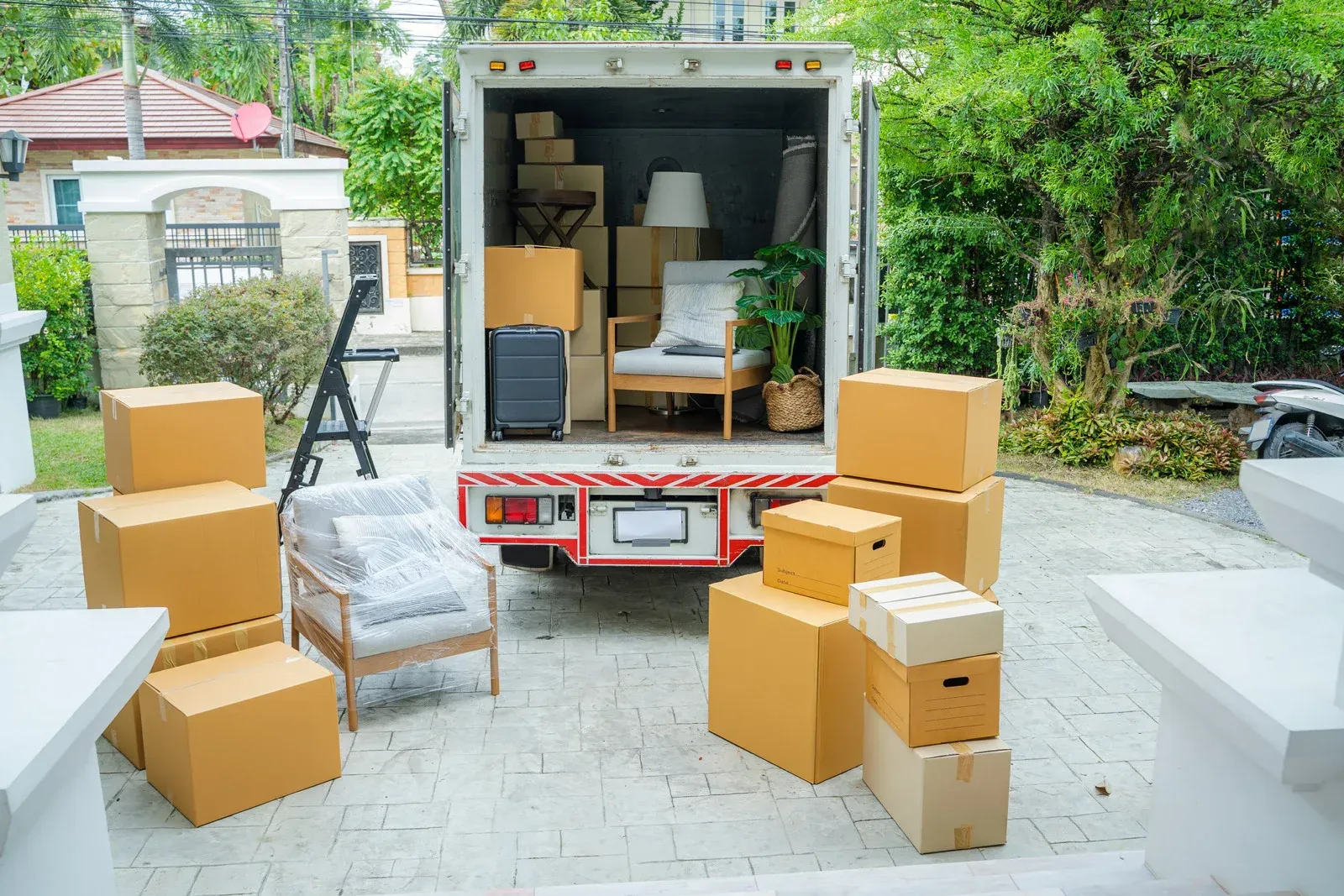 A moving truck is filled with boxes and furniture.