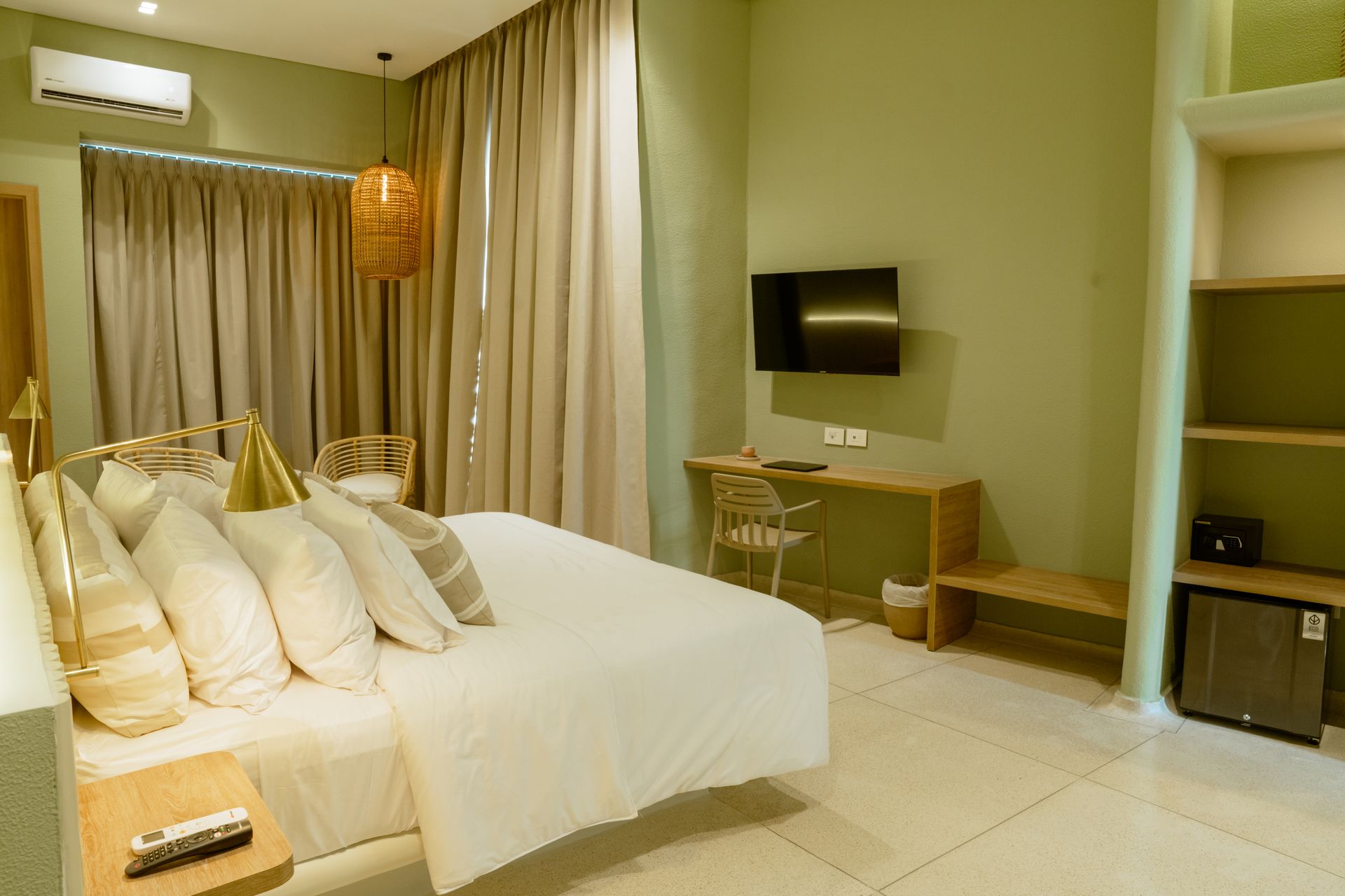 Una habitación de hotel con cama, escritorio y televisión.