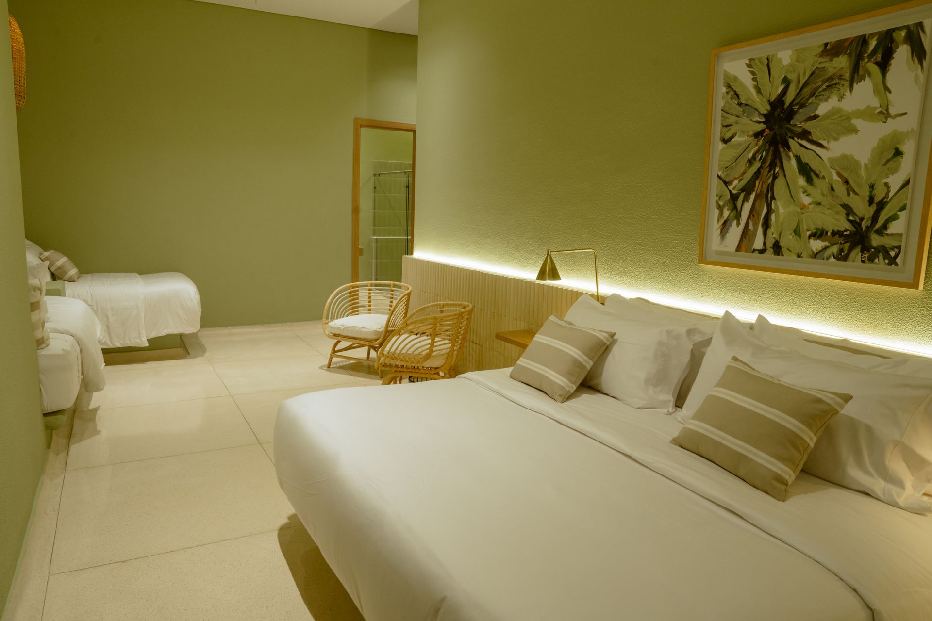 Una habitación de hotel con dos camas y una silla.