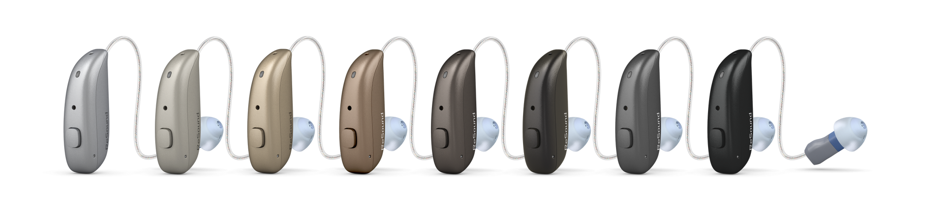 A row of hearing aids of different colors are lined up in a row on a white background.